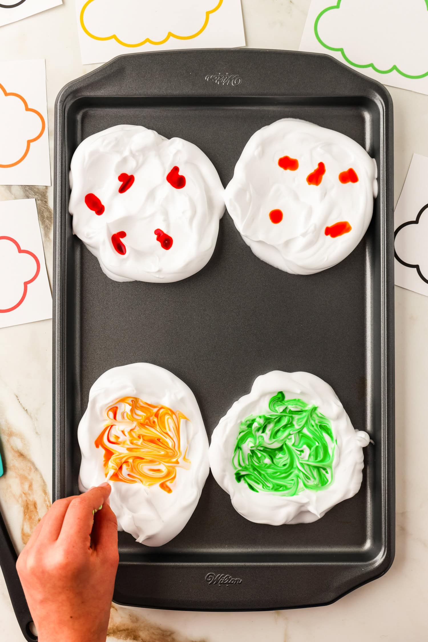Stirring in food coloring into shaving cream clouds with a q-tip for Toilet Paper Roll Fall Tree Craft
