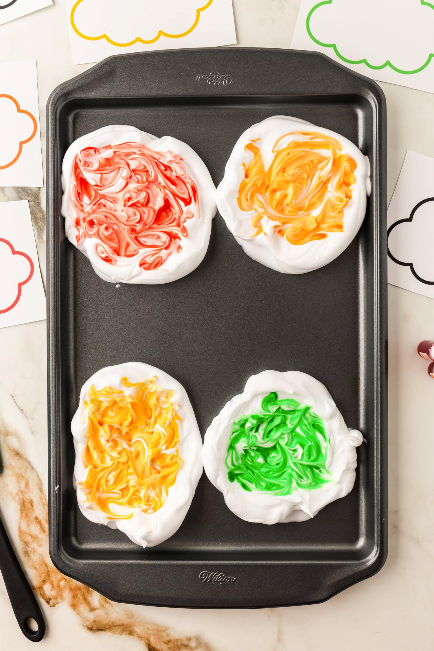 Mixed food coloring in shaving cream clouds on cookie sheet for Toilet Paper Roll Fall Tree Craft