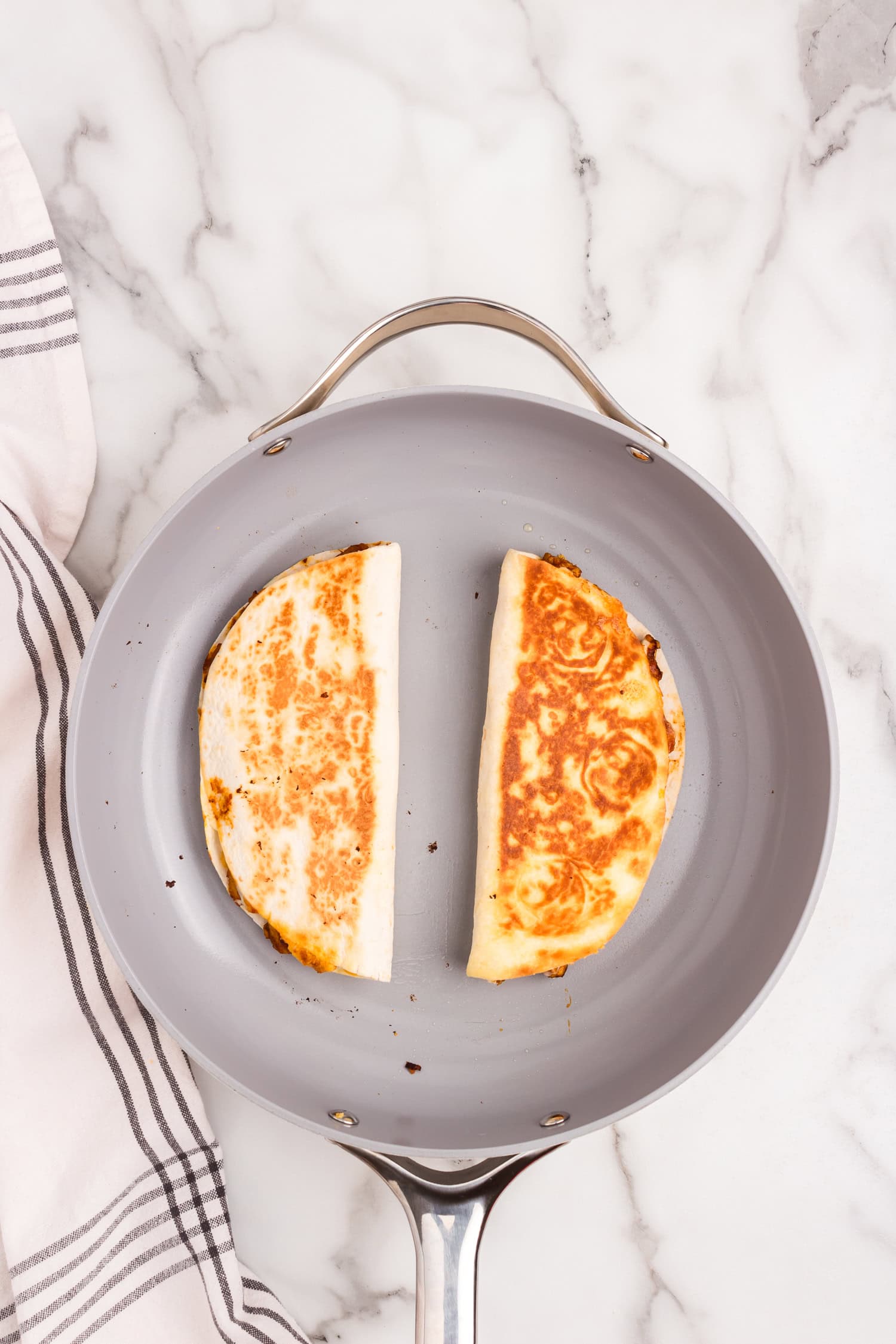 Chicken Quesadillas folded over and cooked to a golden brown in a skillet