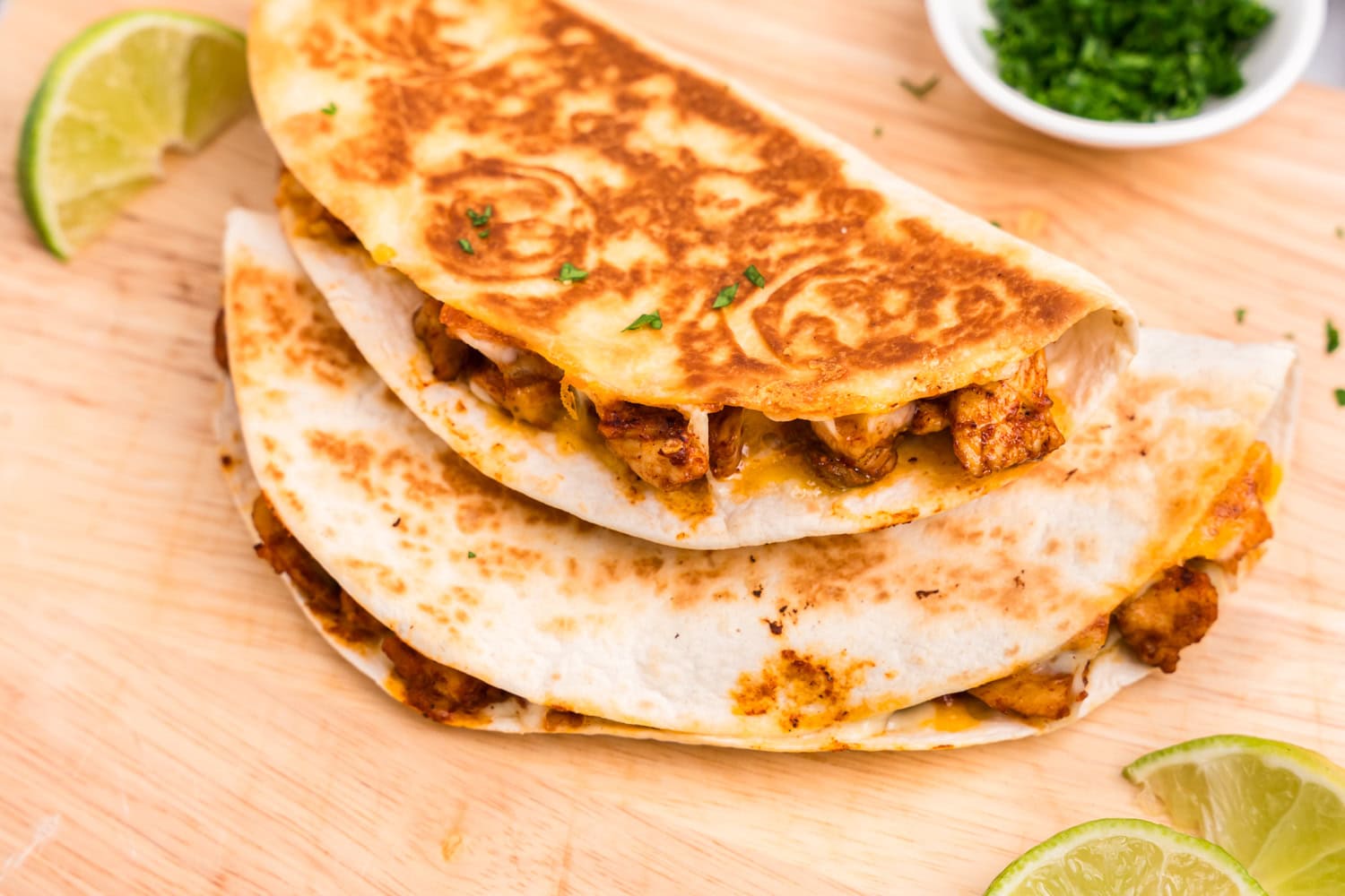 Chicken Quesadillas stacked on platter before cutting