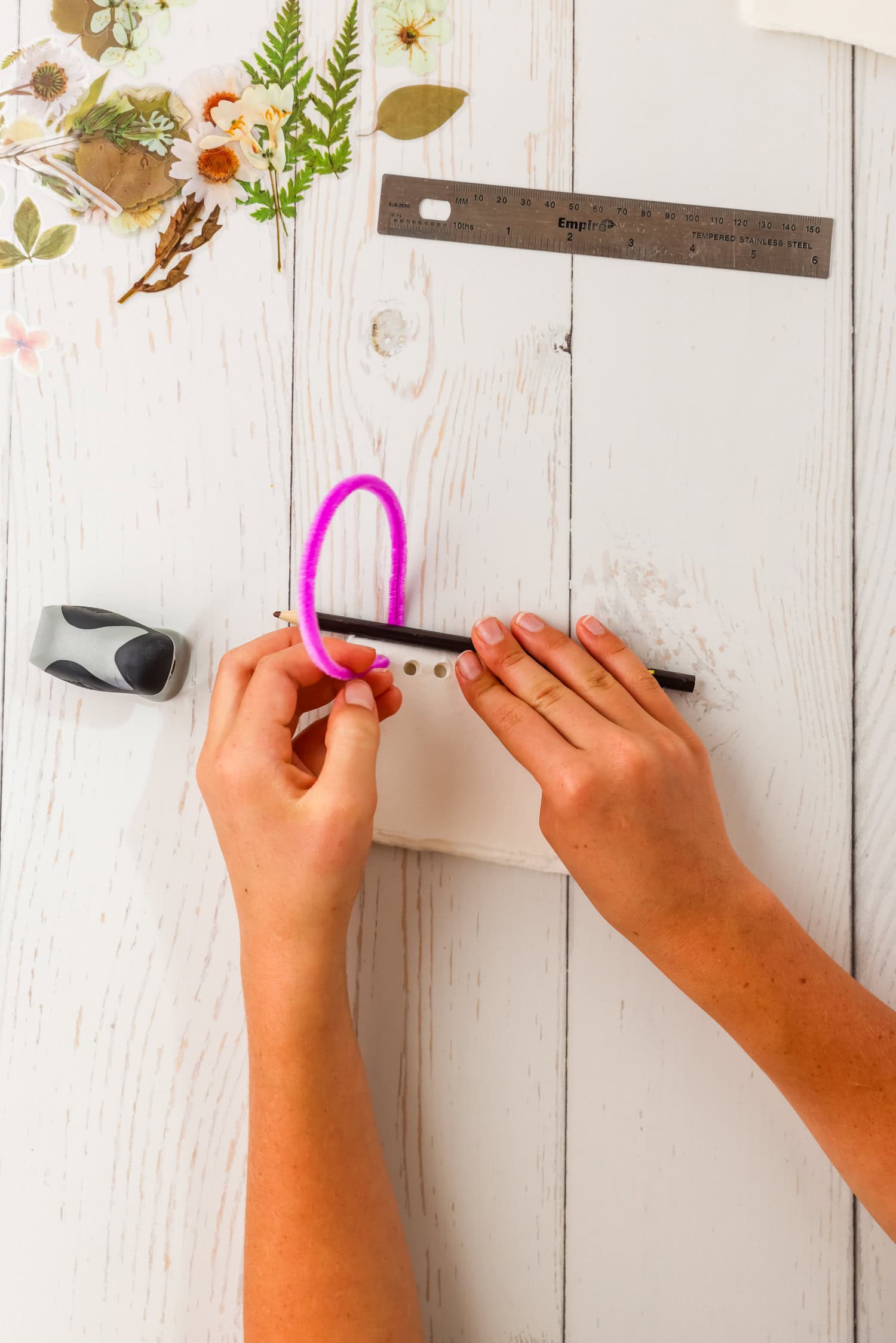 Using pencil to coil pipe cleaner in DIY Sticker Book