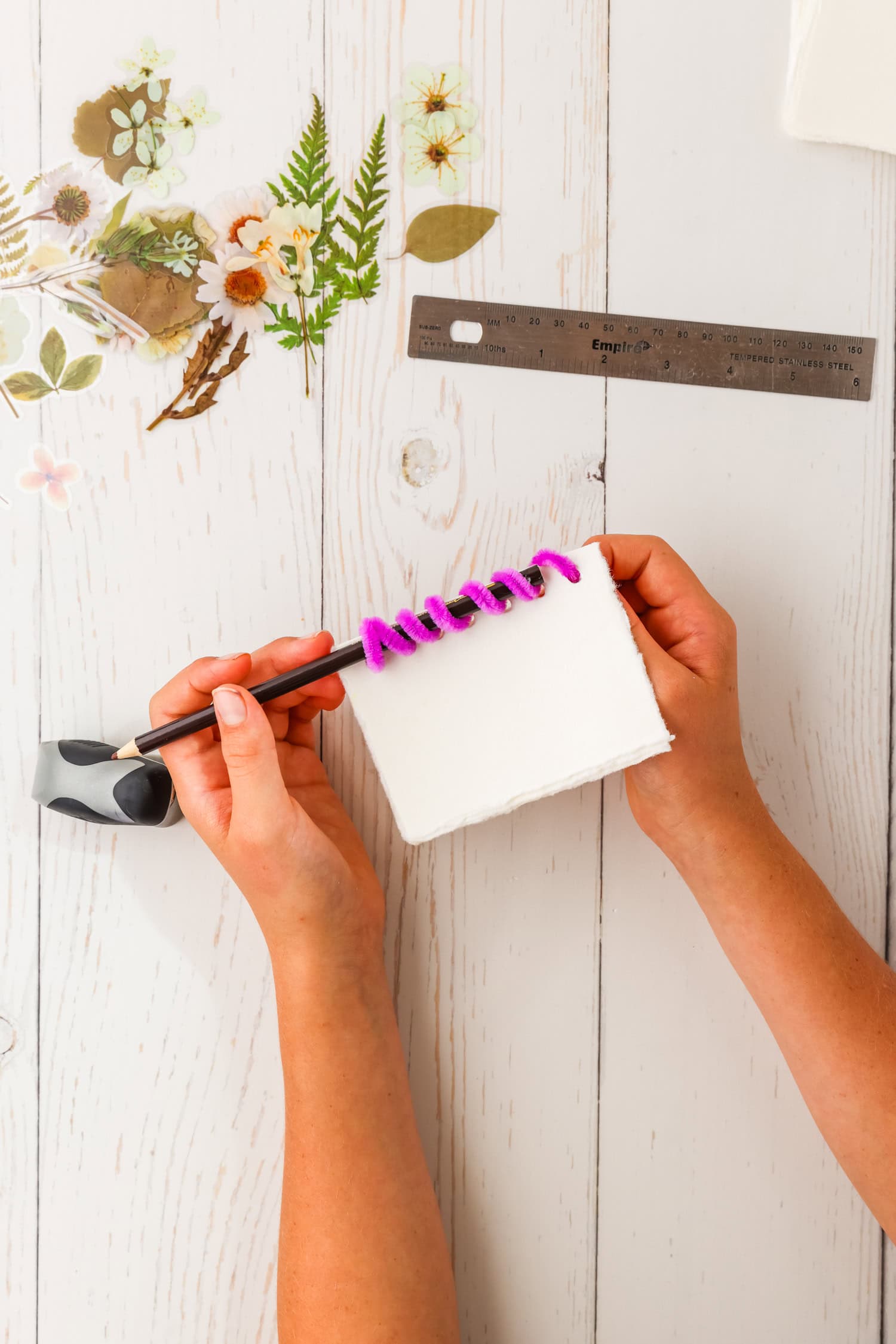 Using a pencil to coin pipecleaner in DIY Sticker Book