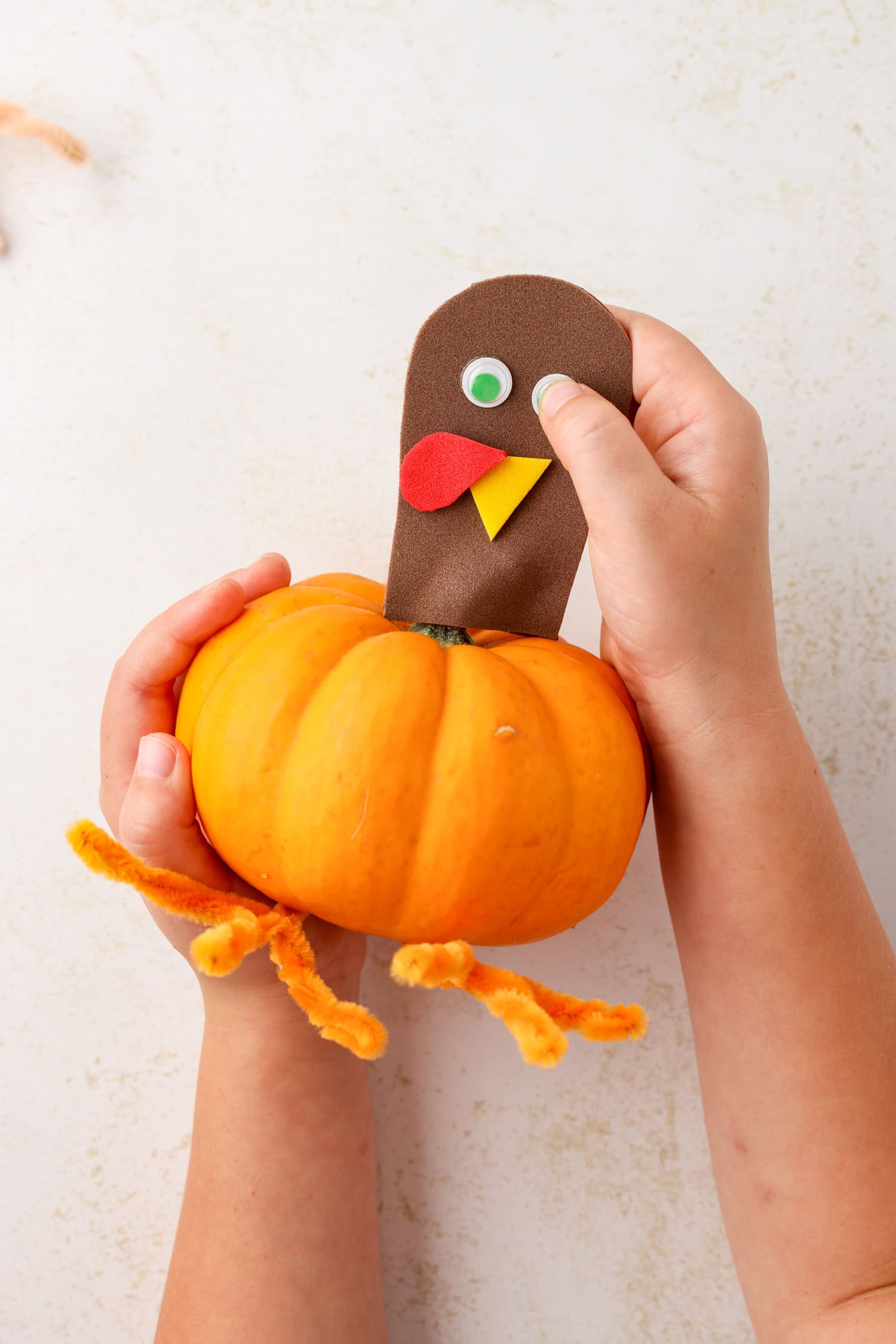 a tiny drop of hot glue to attach the googly eyes if they do not have adhesive backs for Mini Pumpkin Turkey Craft