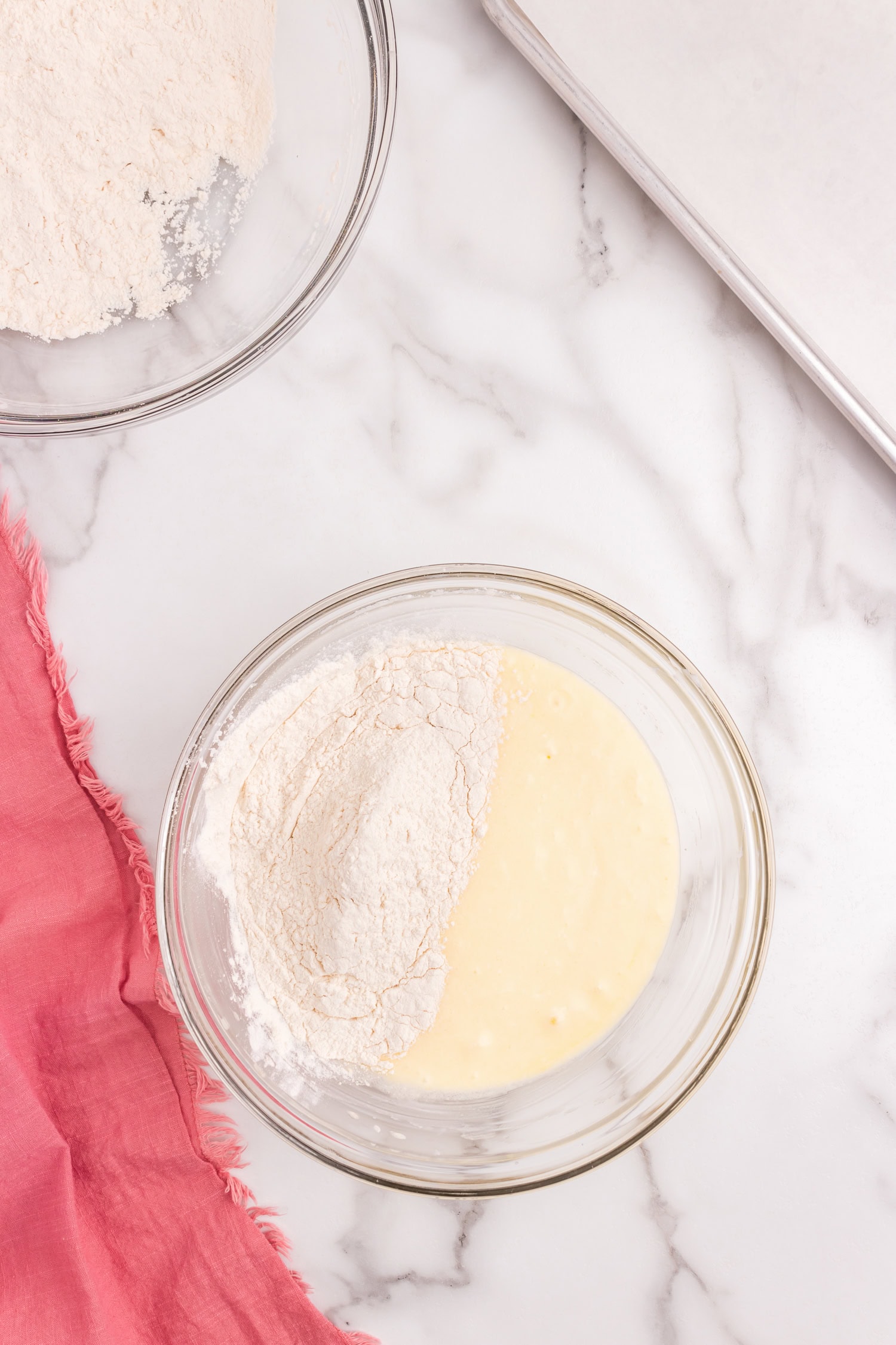 Adding more flour to Sour Cream Cookie dough in glass mixing bowl