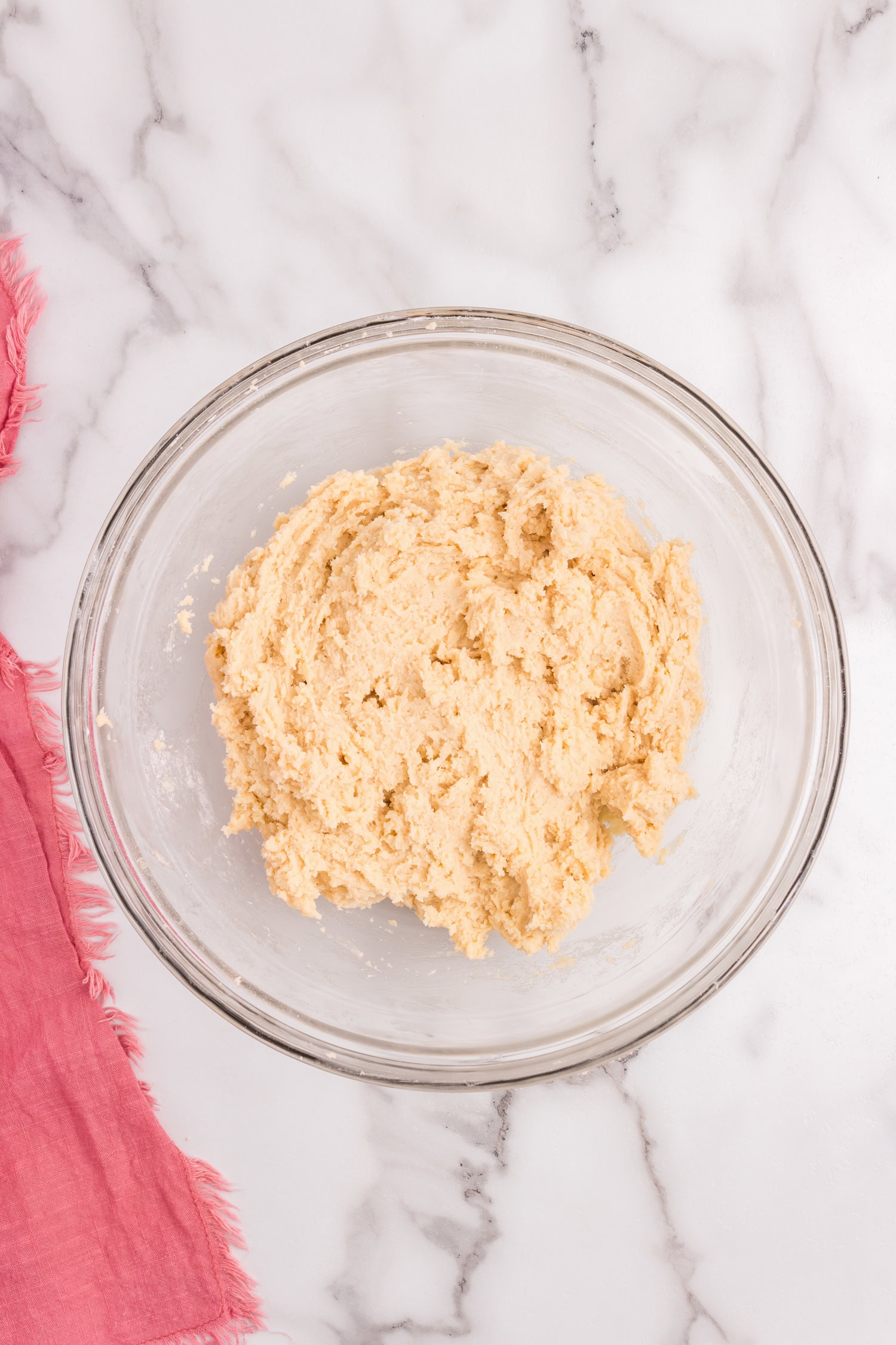 Sour Cream Cookie batter mixed together in glass mixing bowl