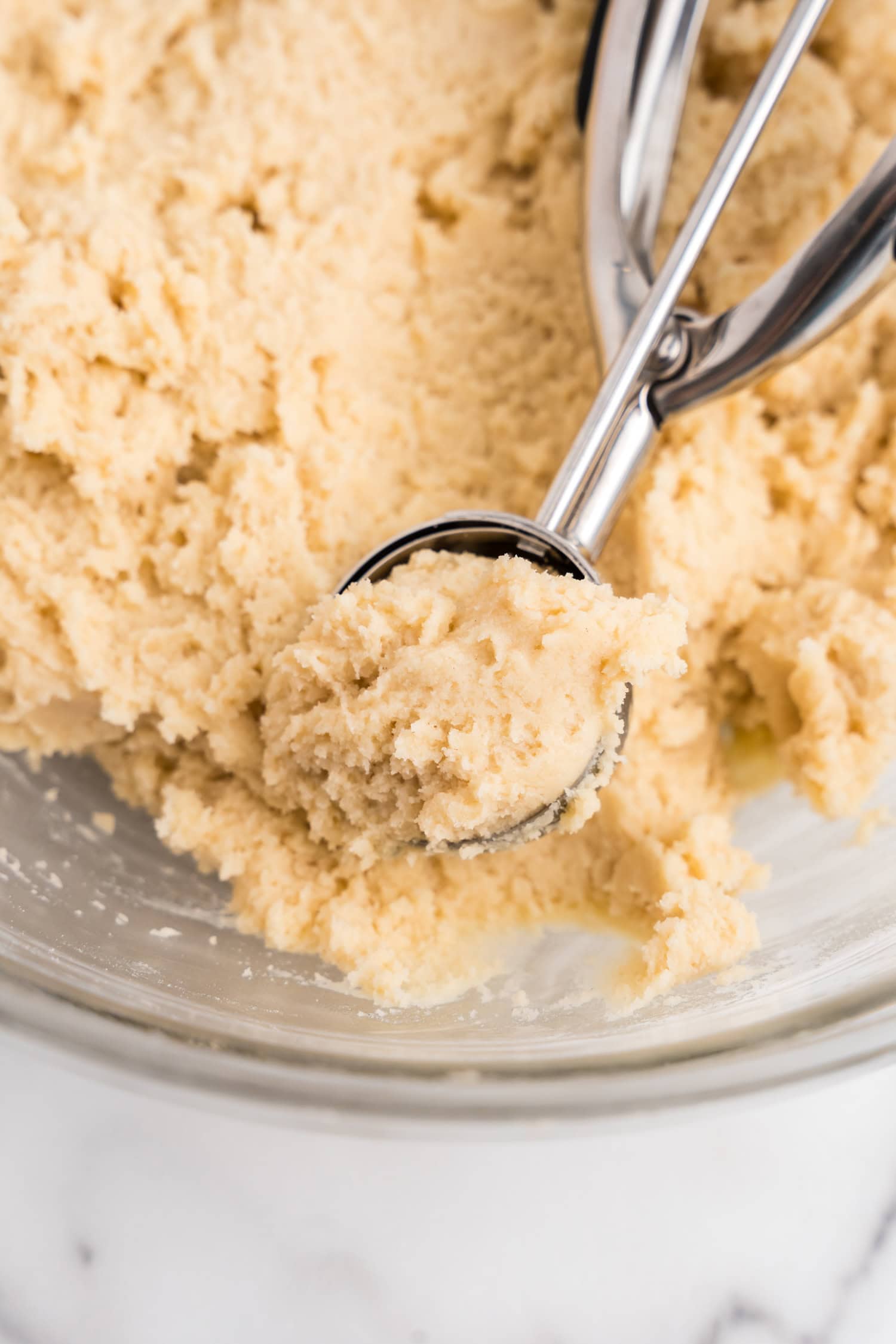 Using scoop to lift Sour Cream Cookie dough from bowl