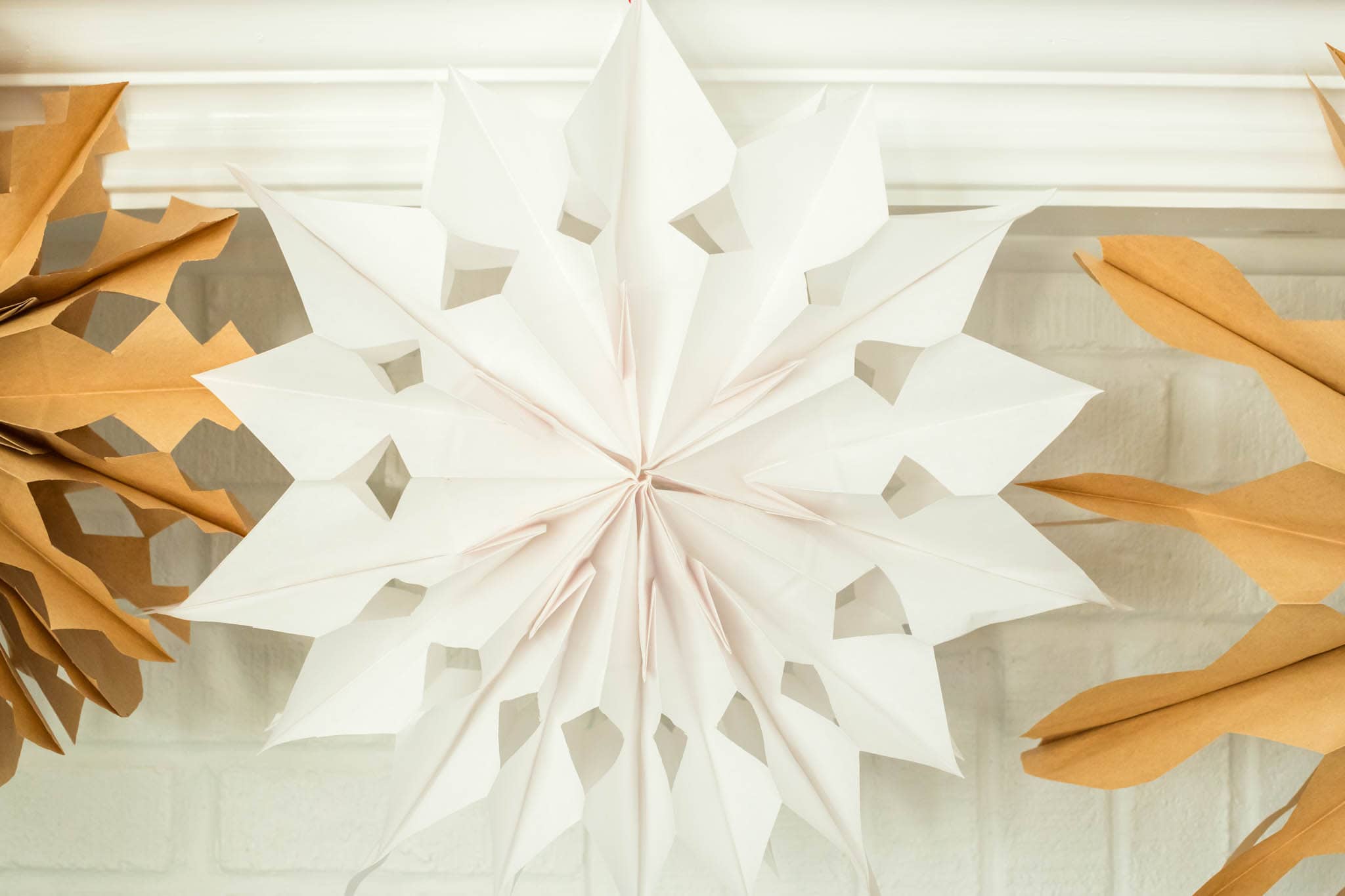 Close up image of completed paper bag snowflakes.