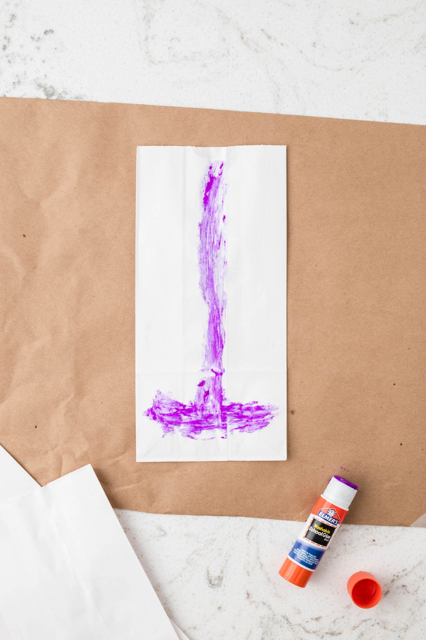 Overhead picture of white paper bag with glue on it.