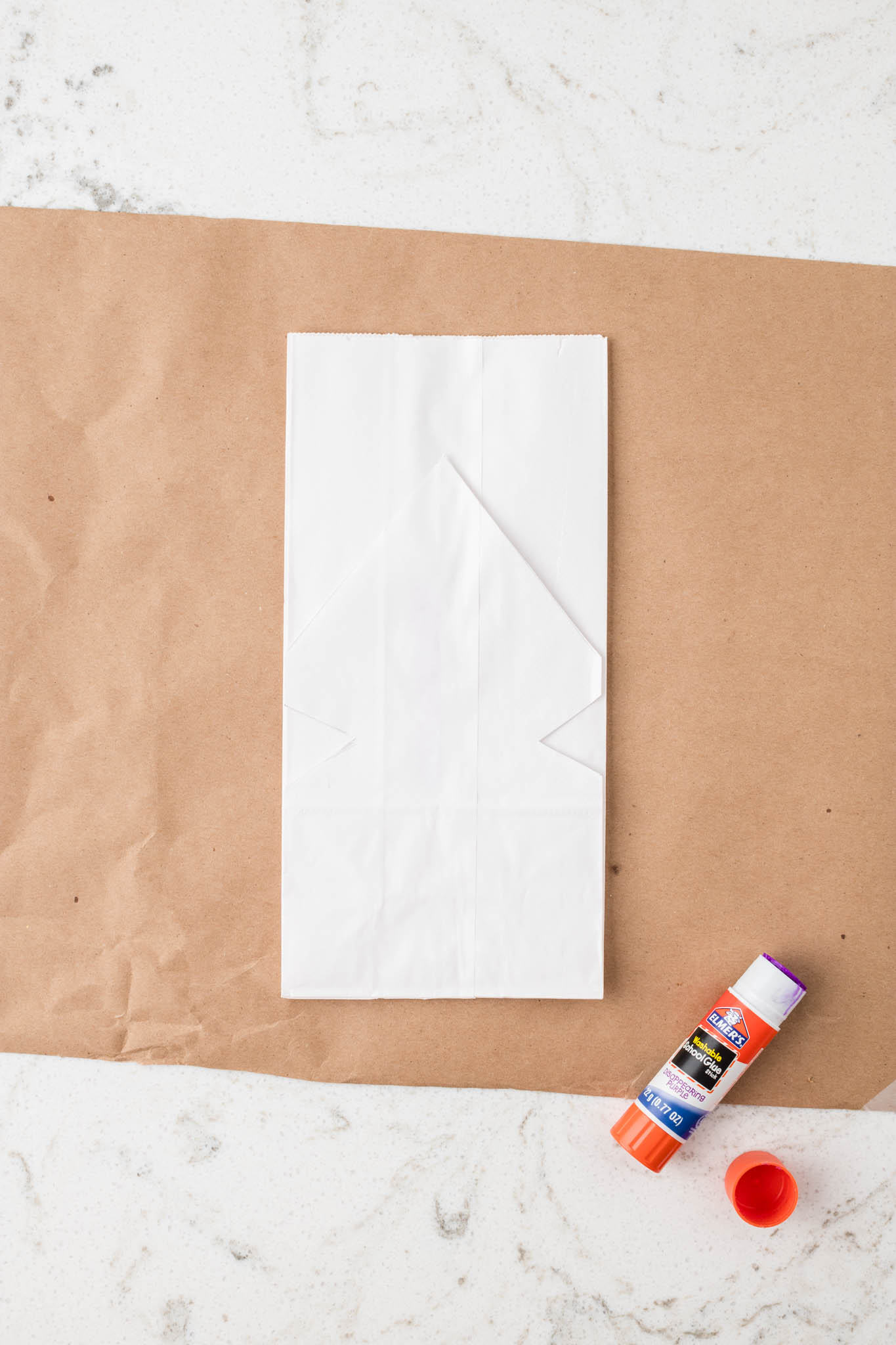 Overhead picture of paper bag with the cut paper bag on it as a stencil.