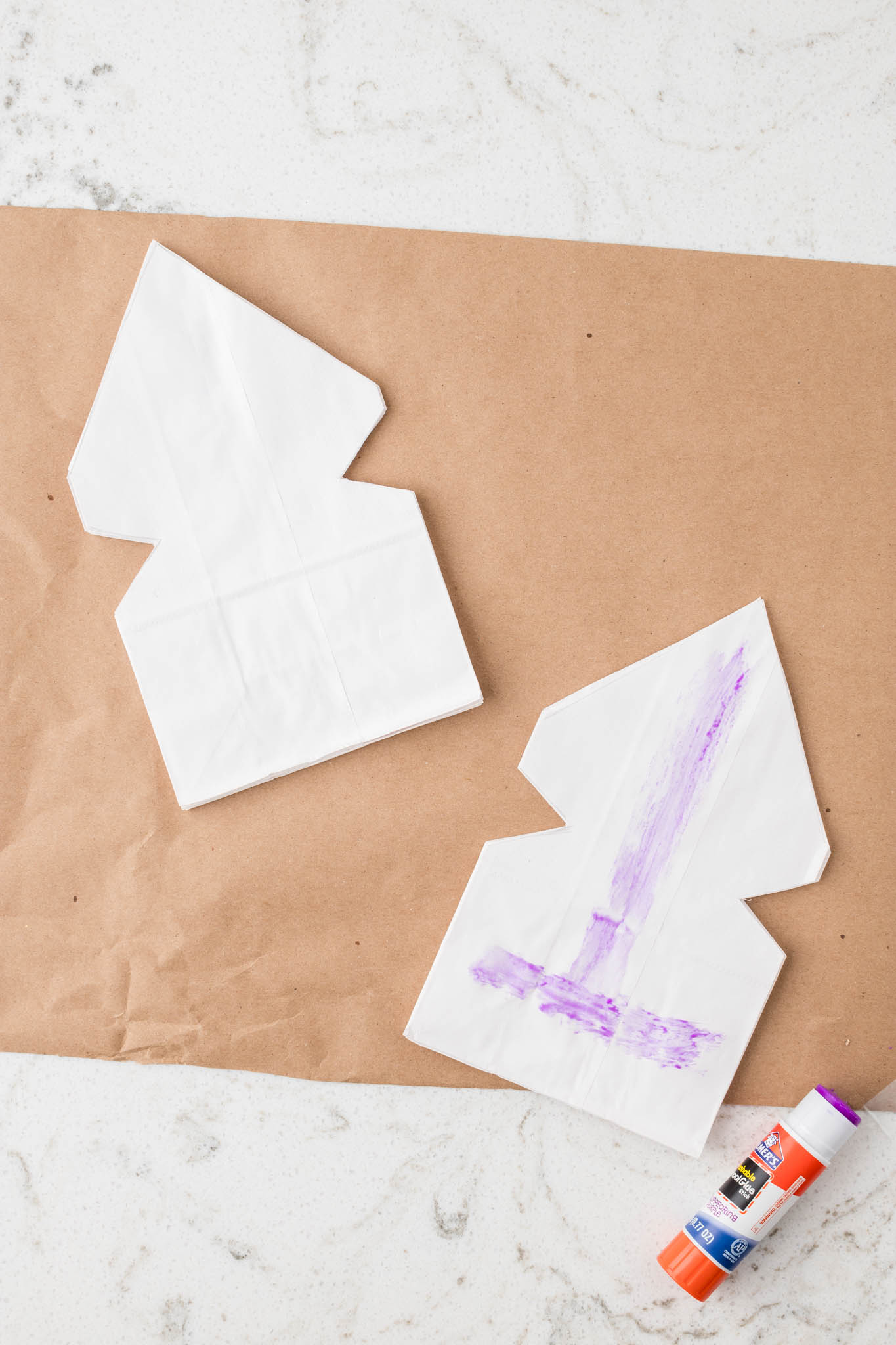 Overhead picture of two cut paper bags with glue on one.