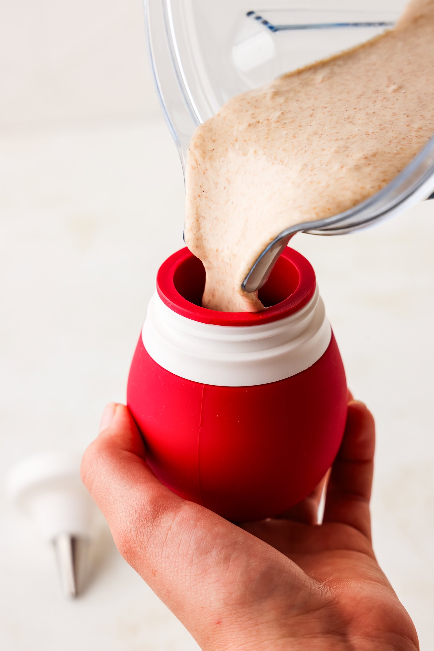 Frosting bulb being filled with pancake mix.