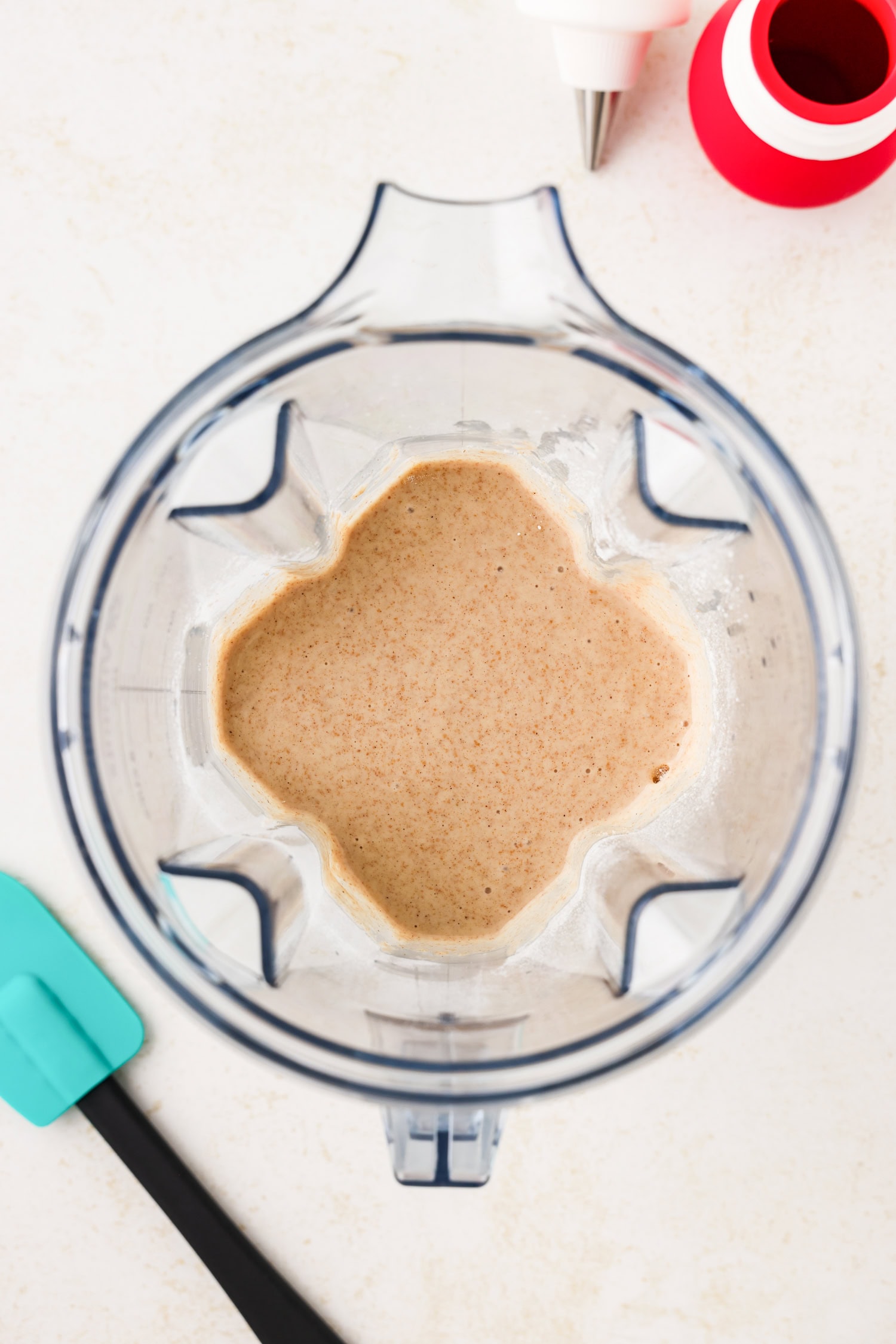 Blender with dry and wet ingredients combined in it.
