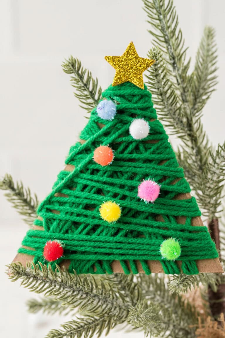 Close up picture of completed Yarn Wrapped Christmas Trees positioned on a real Christmas tree.