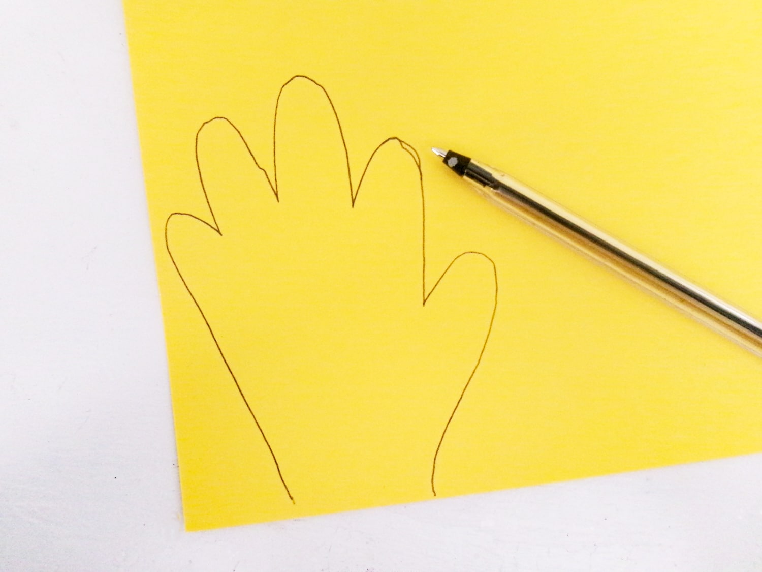 Trace two handprints on yellow cardstock.