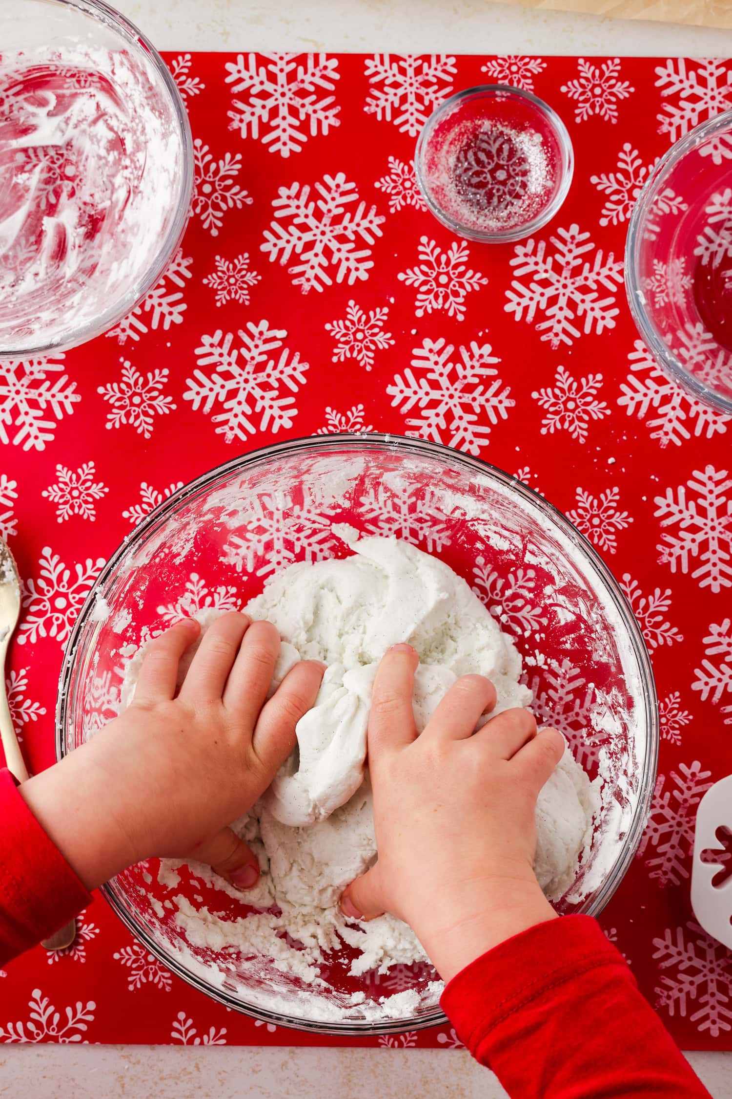 Overhead picture of glass bowl with mixed snow dough in it.