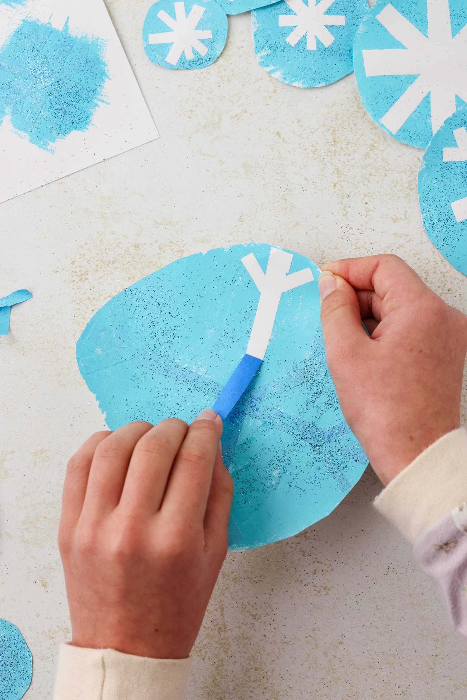 Close up picture of tape being pulled off of the painted spot.