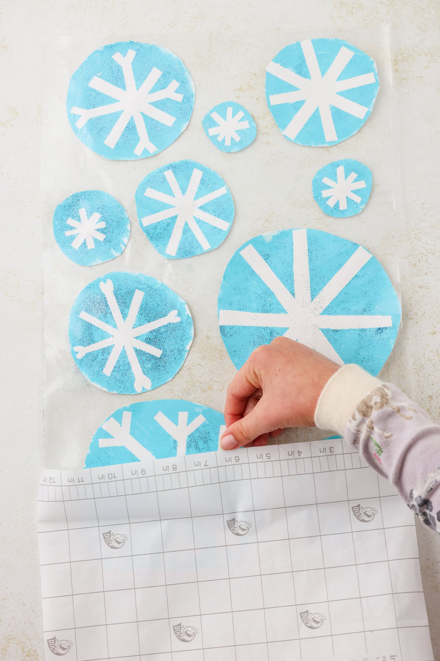 Overhead picture of contact paper backing being pulled off.