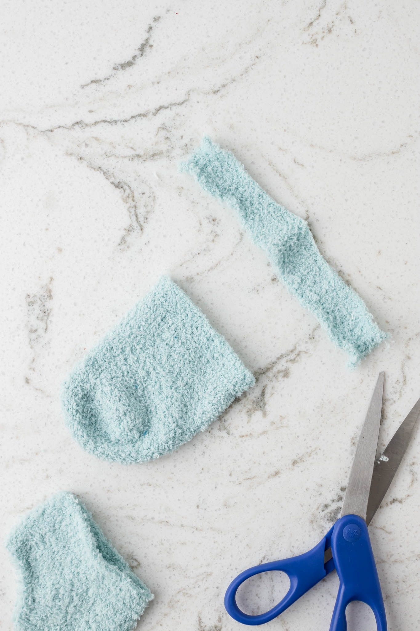 Picture of fuzzy sock cut in half at the toe portion and a long rectangular strip.