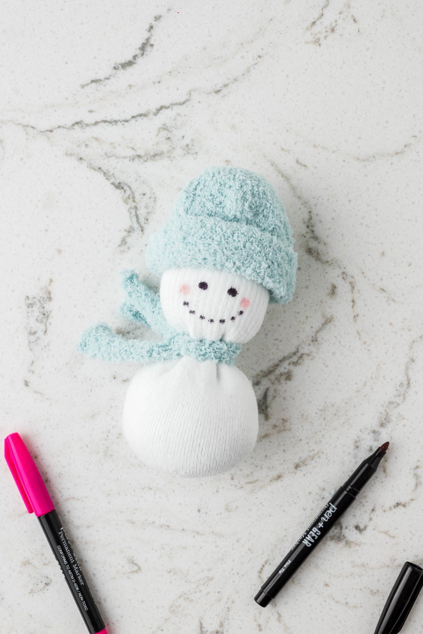 Picture of sock snowman with face drawn on.