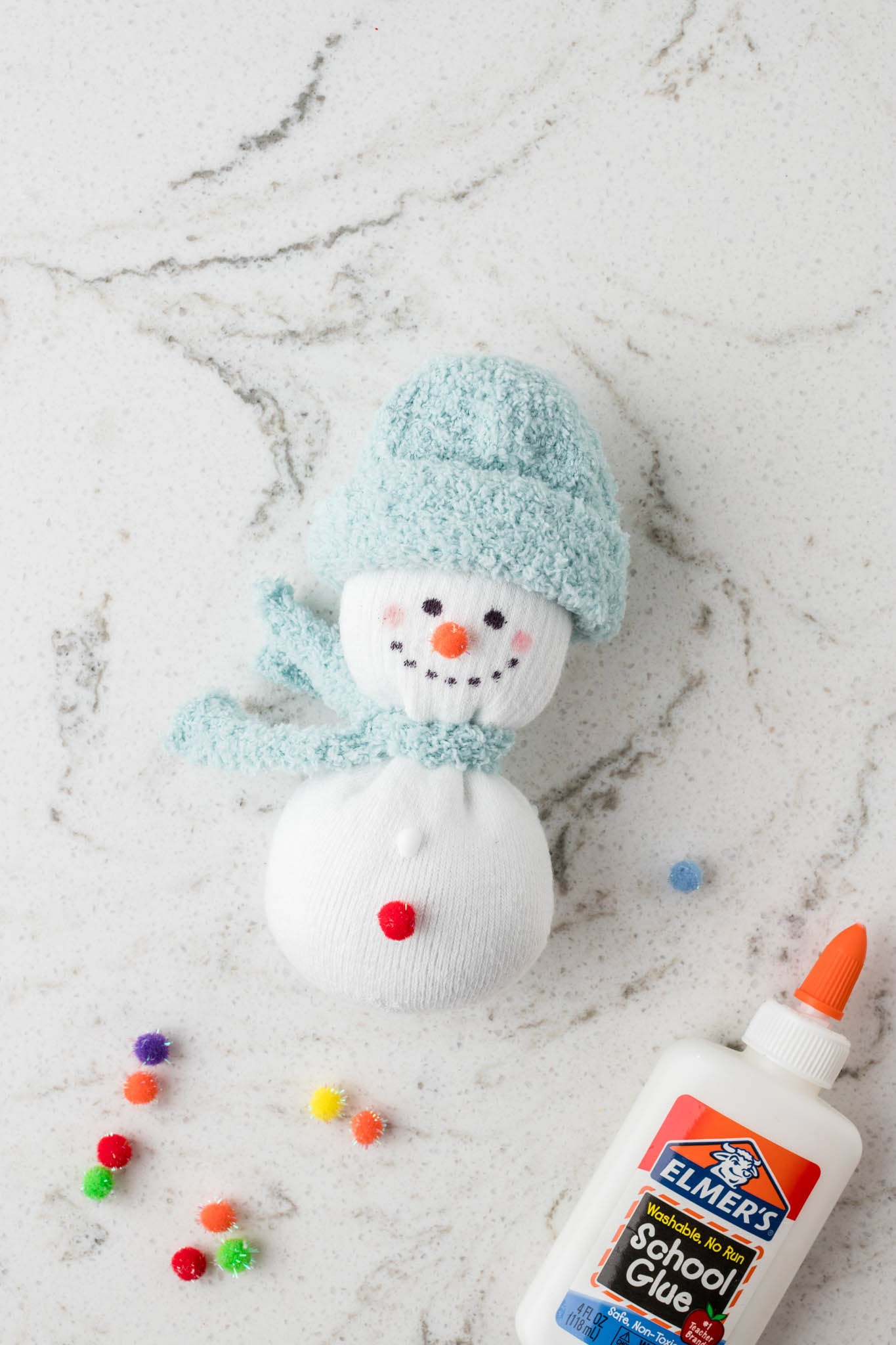 Picture of sock snowman with pom poms glued on.
