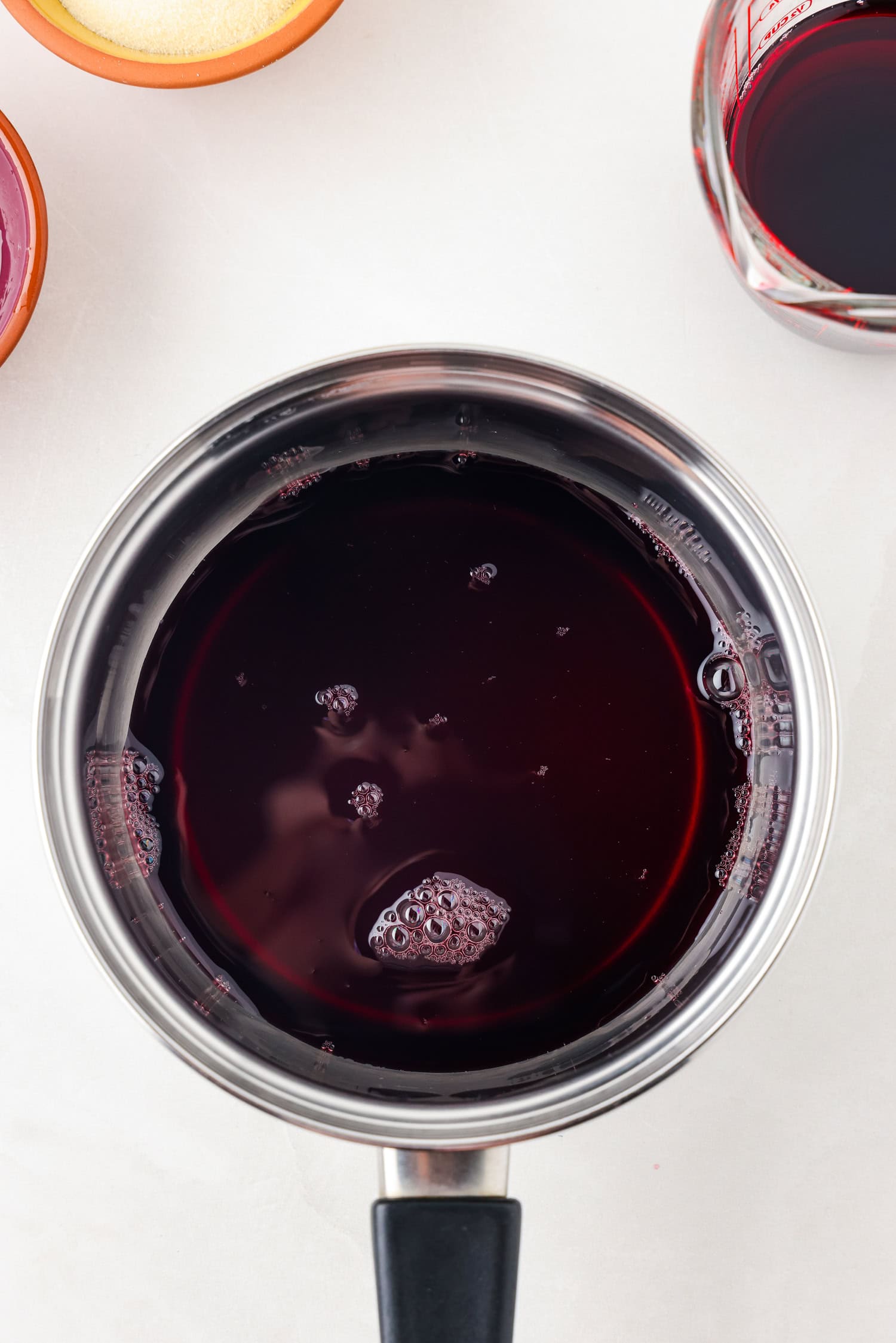 Picture of purple gummy bear ingredients in a sauce pan.