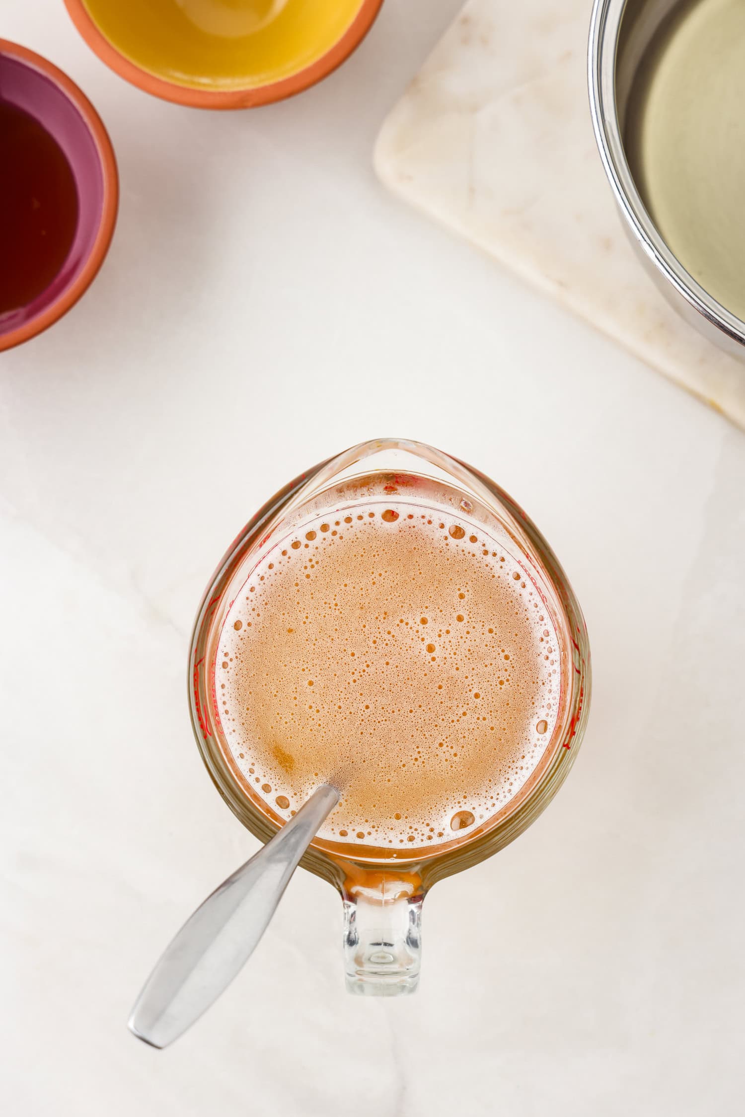 Picture of of apple juice in a glass measuring cup.