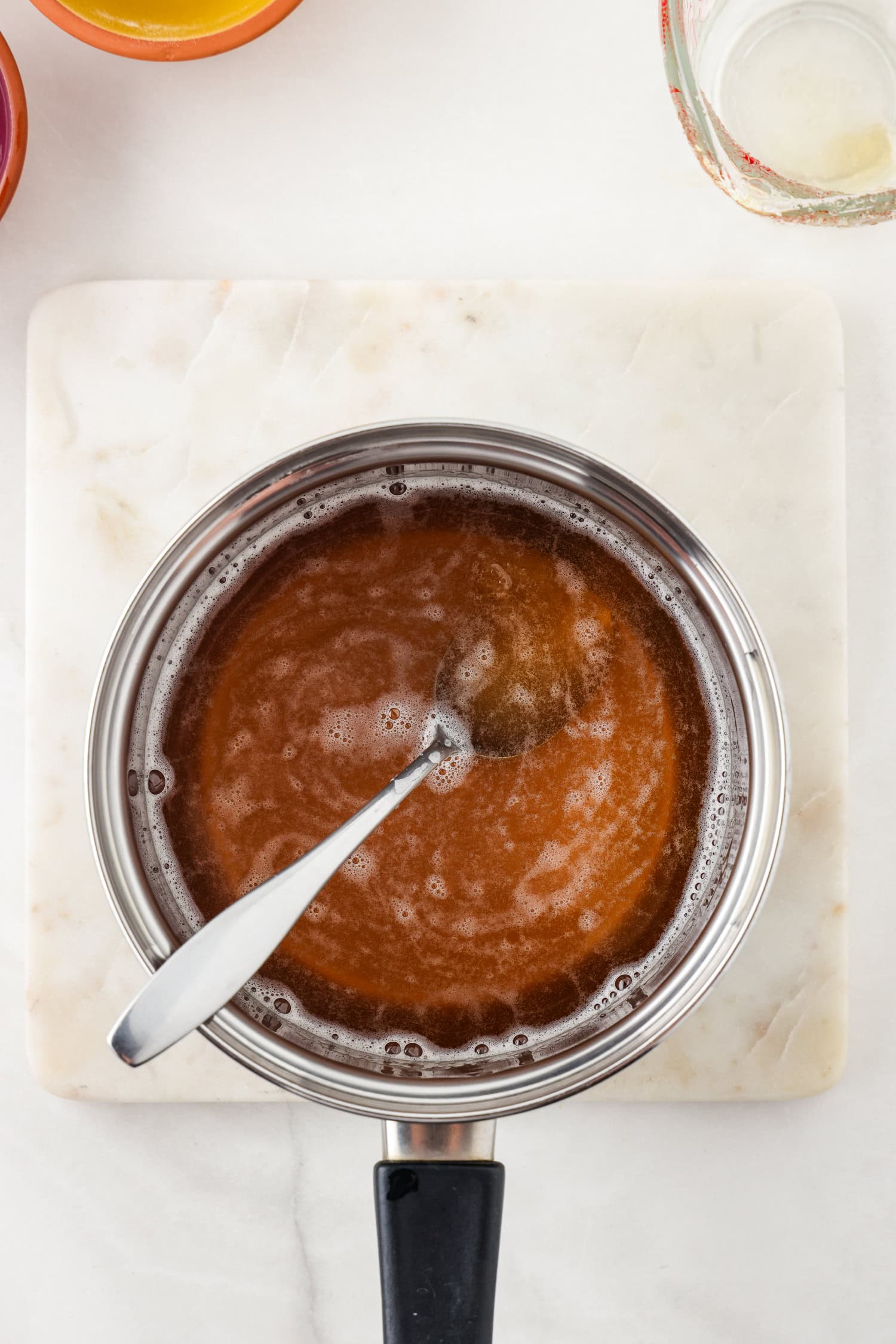 Picture of apple juice gummy bear ingredients in a sauce pan.