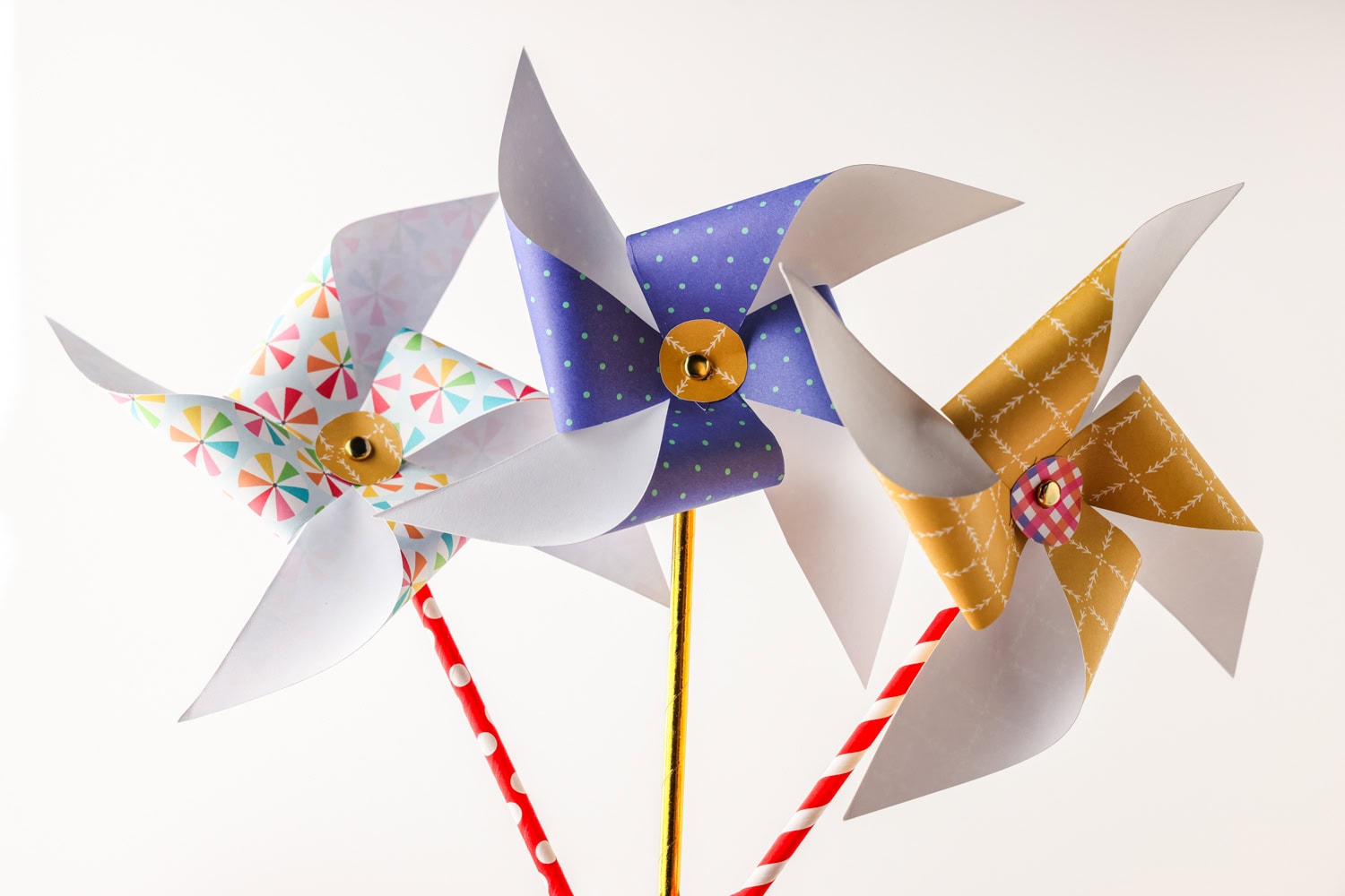 3 complete paper pinwheels next to eachother.
