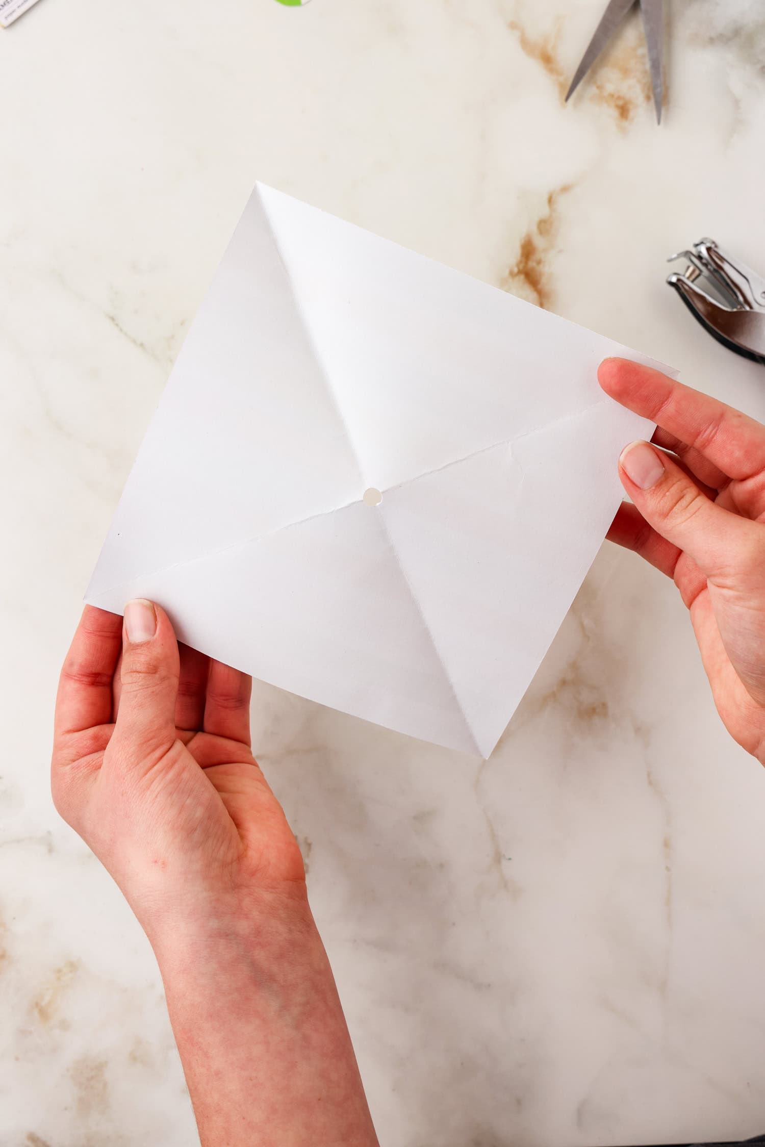 Square paper unfolded with 2 separate creases showing.