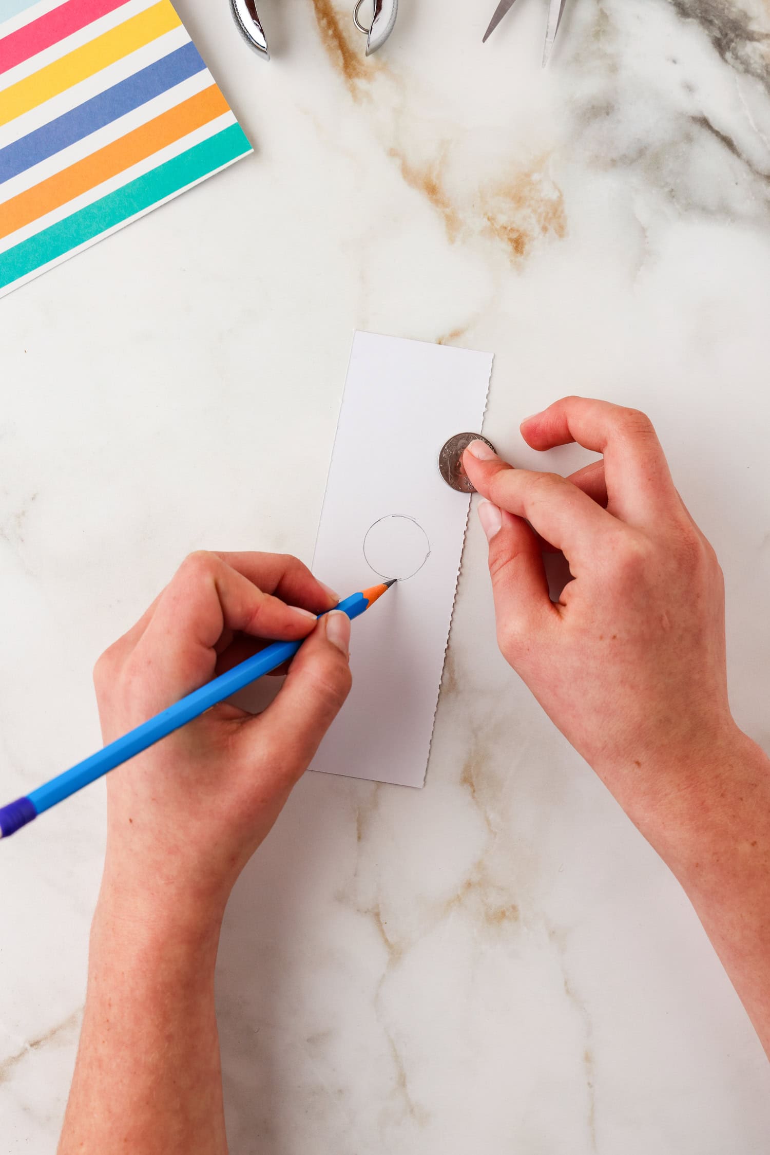 Drawing a thick line over the traced coin outline.