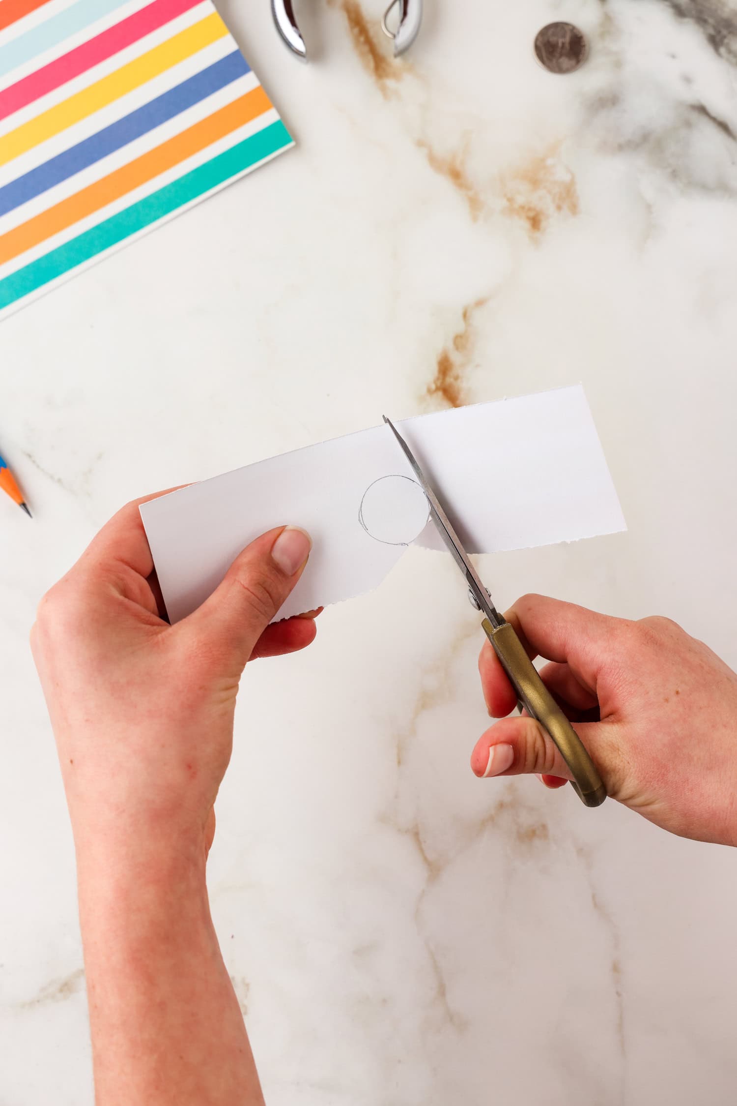 Cutting out the circle on the paper.
