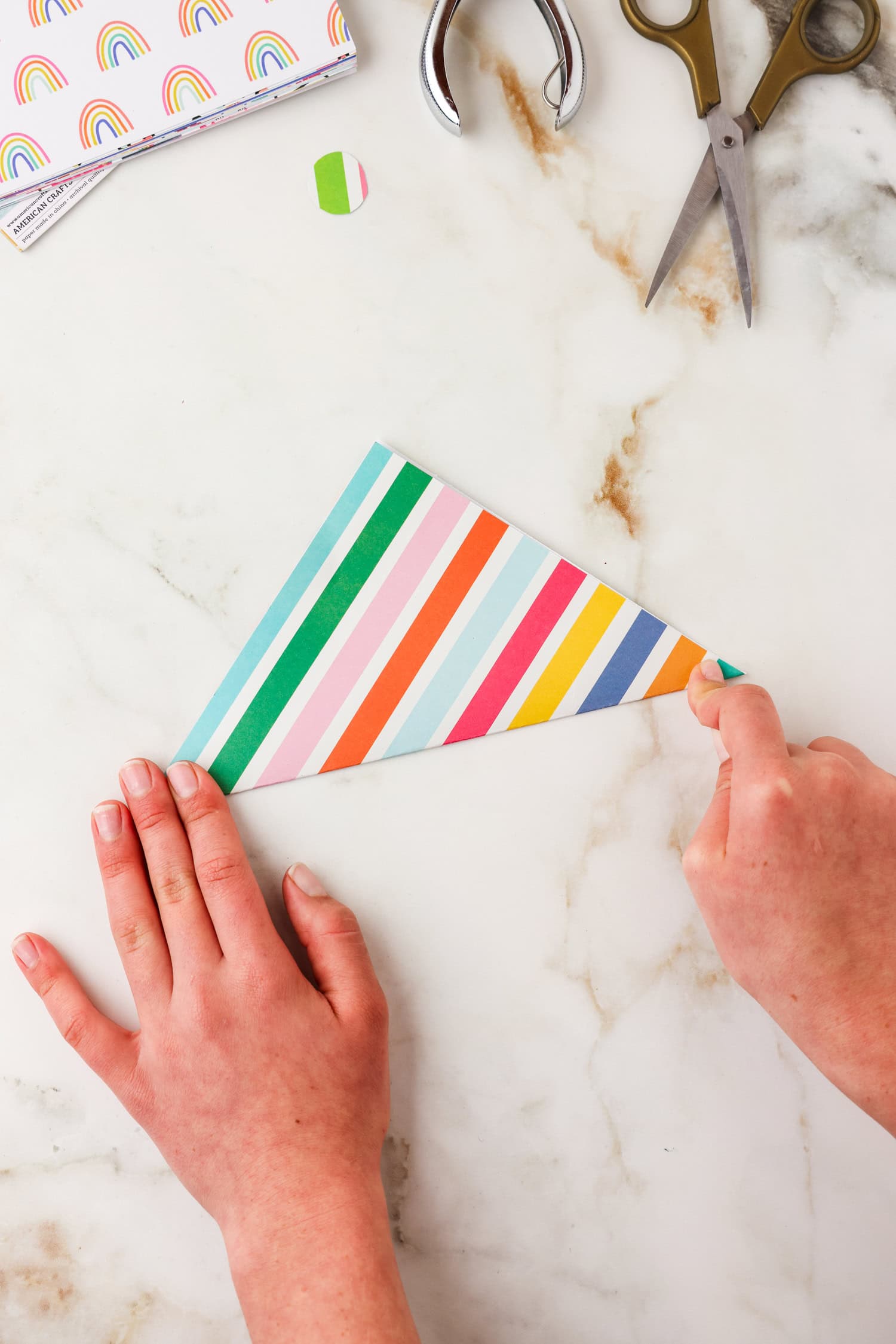 Piece of paper folded in half corner to corner to make a triangle.