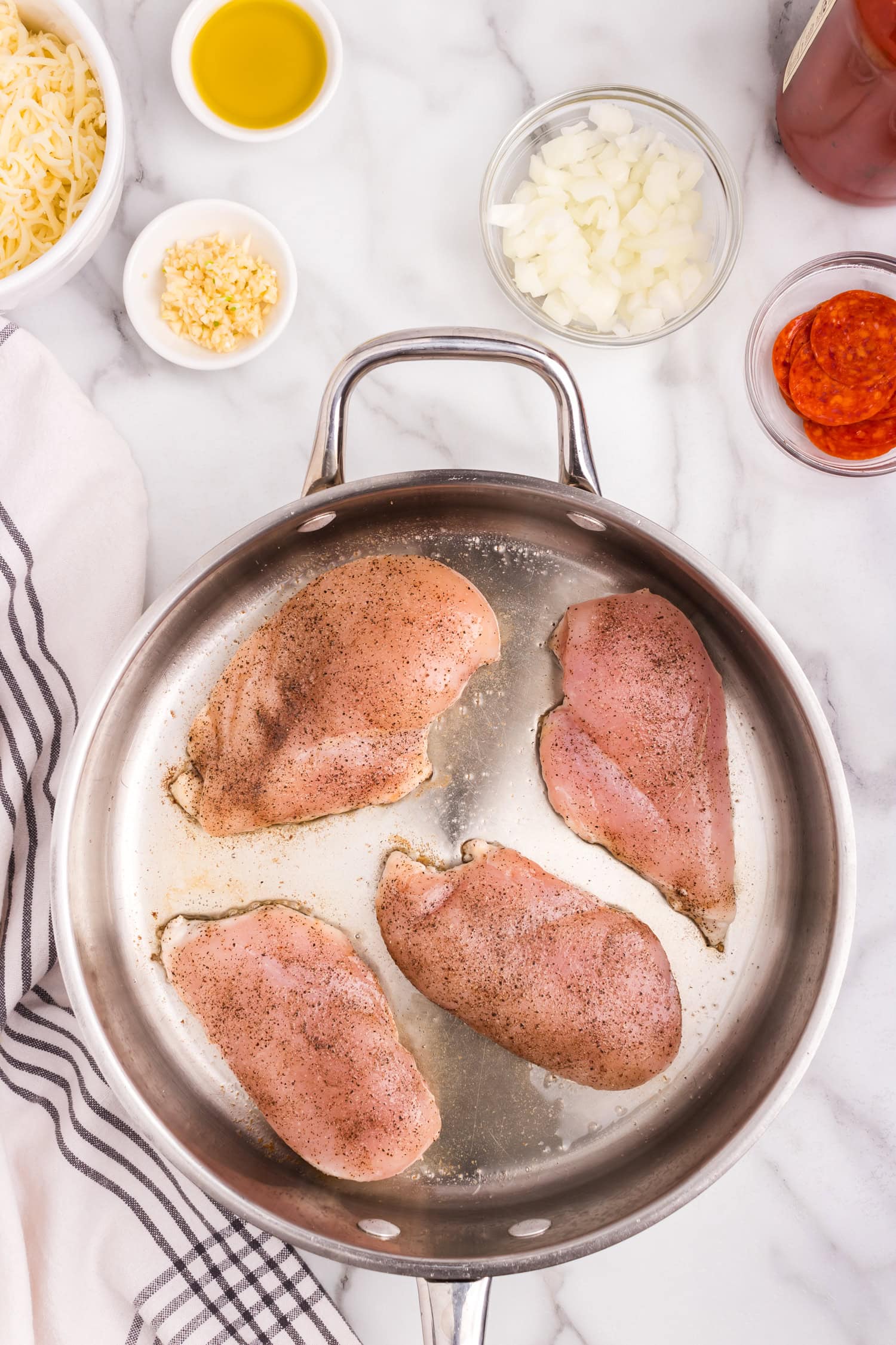 Overhead picture of raw chicken breast in pan.