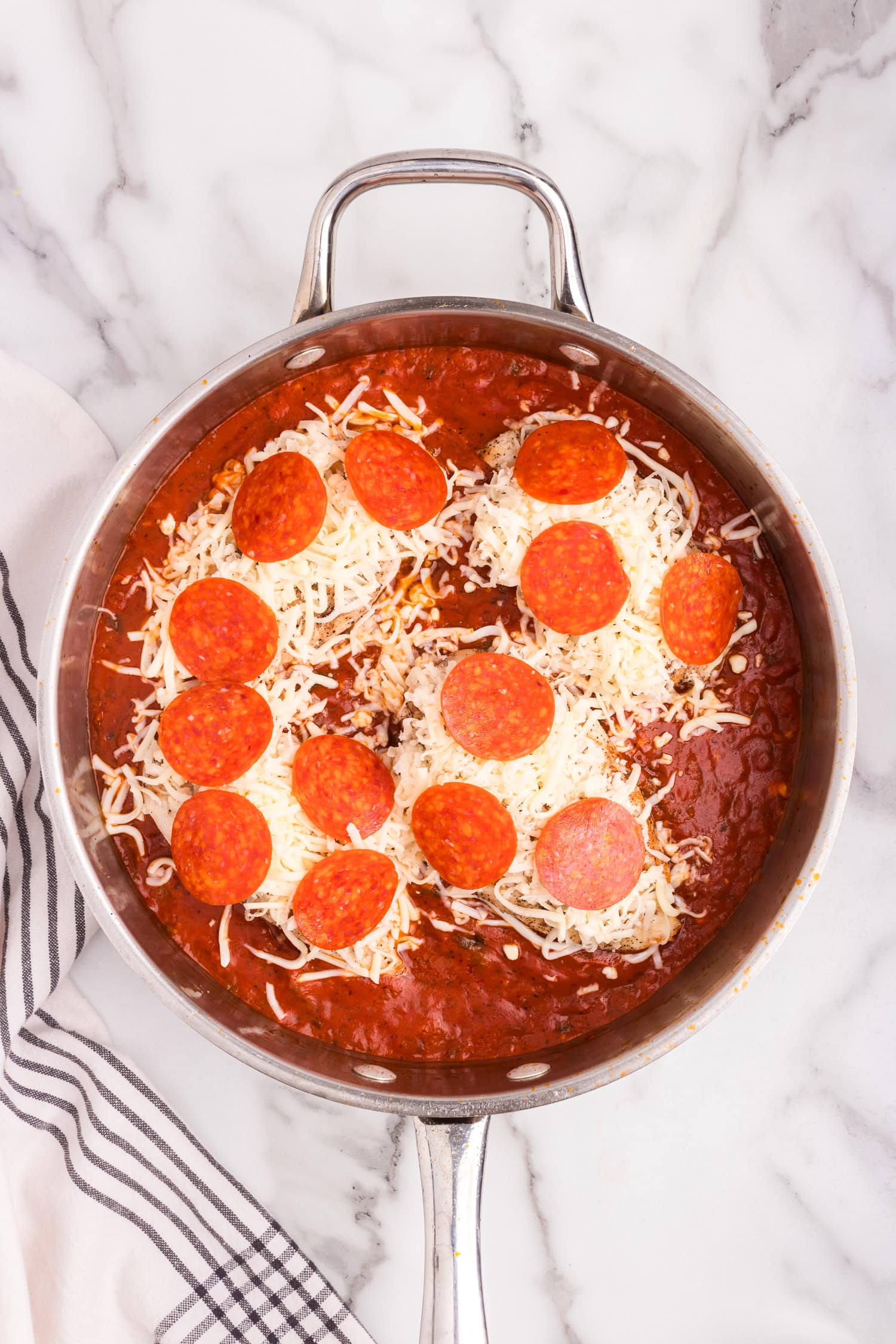 Overhead picture of pizza chicken with mozzarella cheese unmelted.