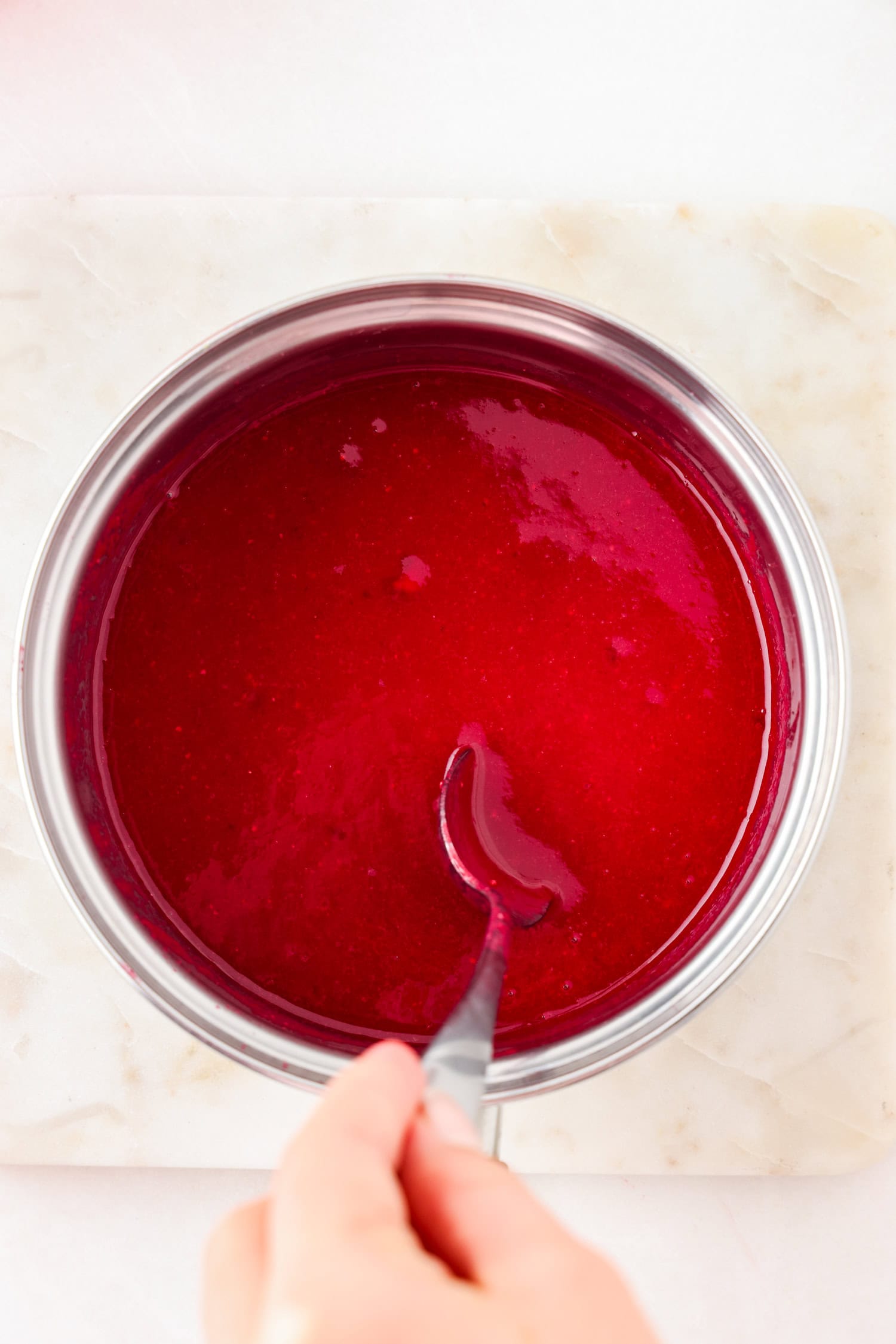 Red fruit mixture blended in a sauce pan.