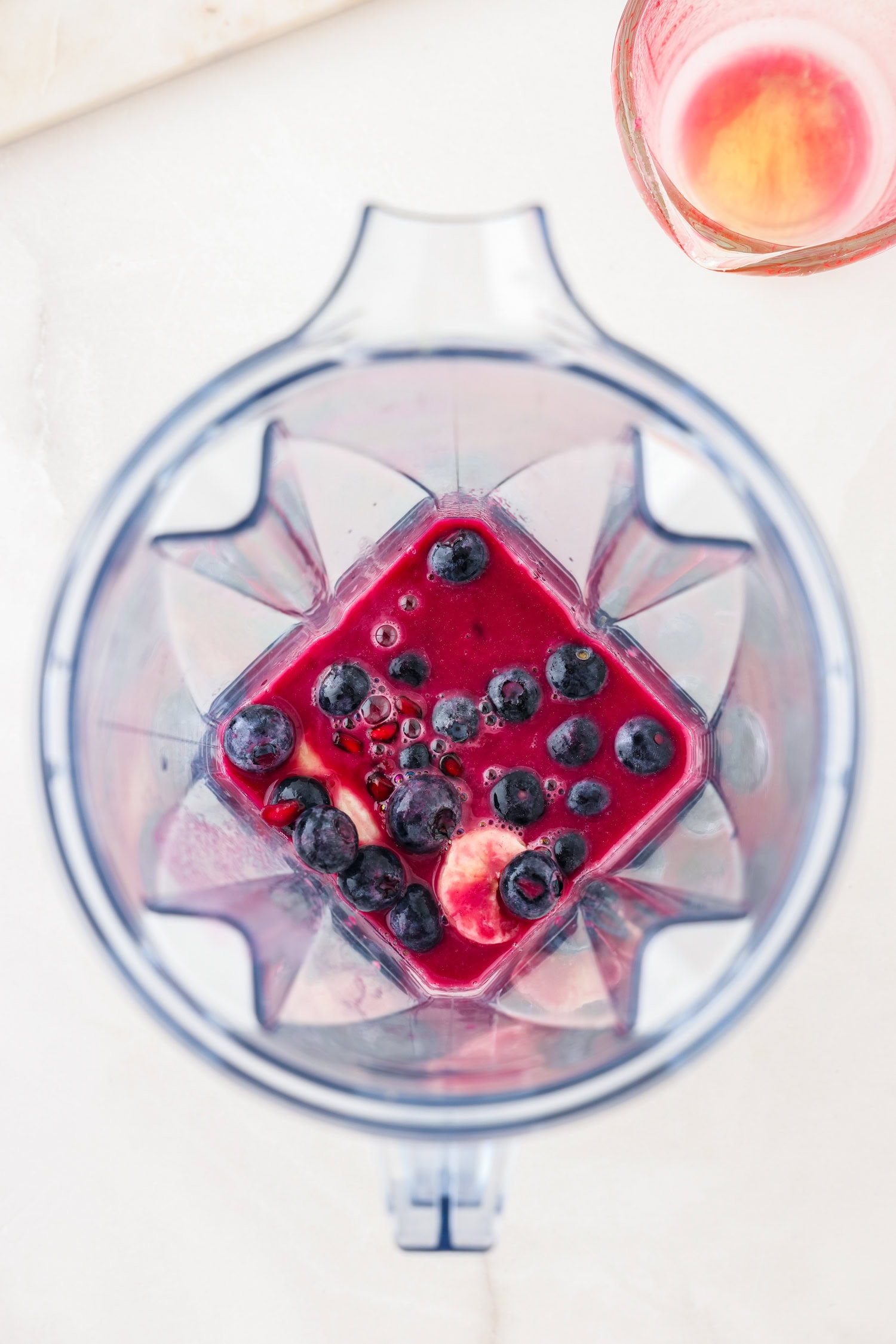 Purple fruit ingredients in a blender.