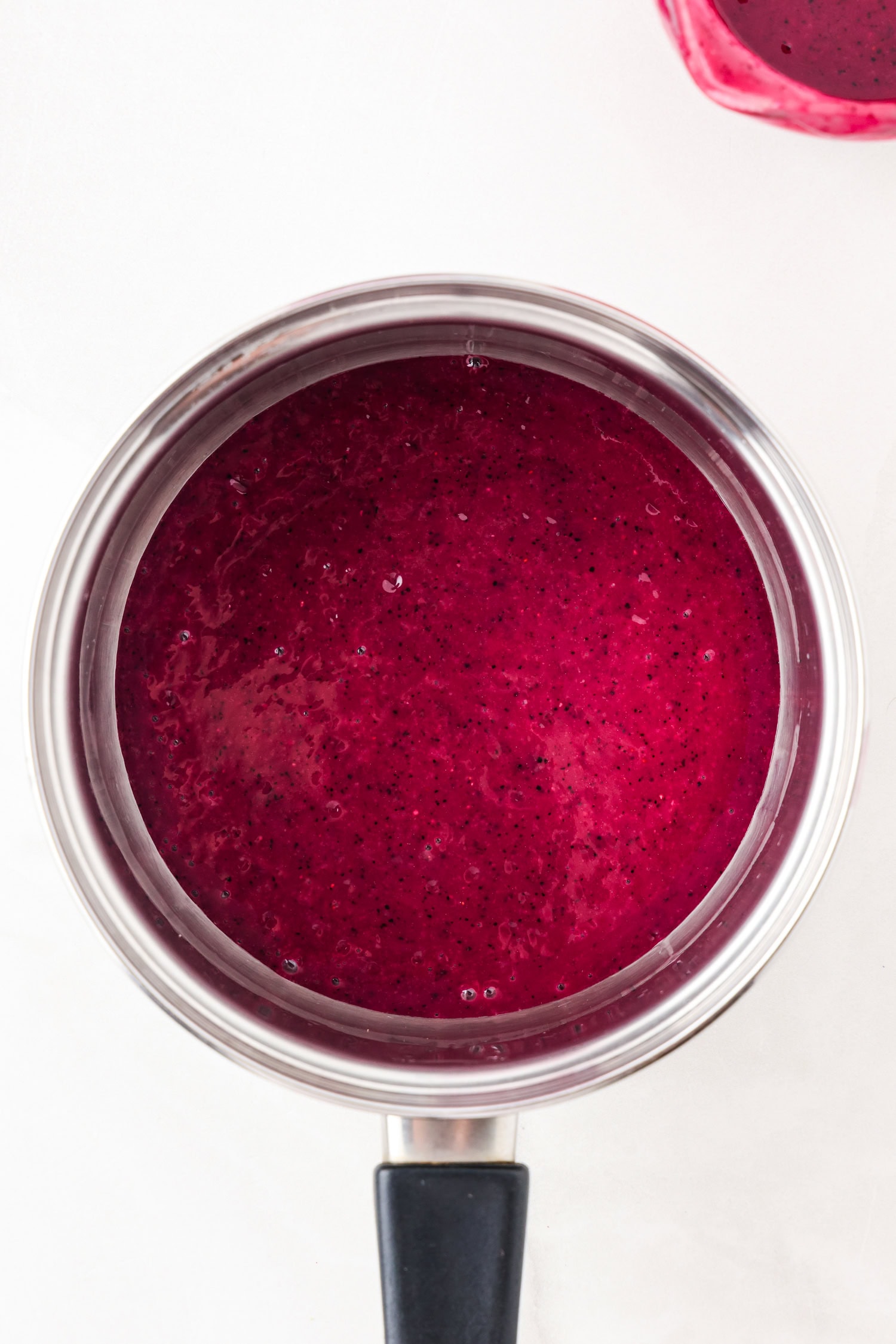Purple fruit mixture blended in a sauce pan.