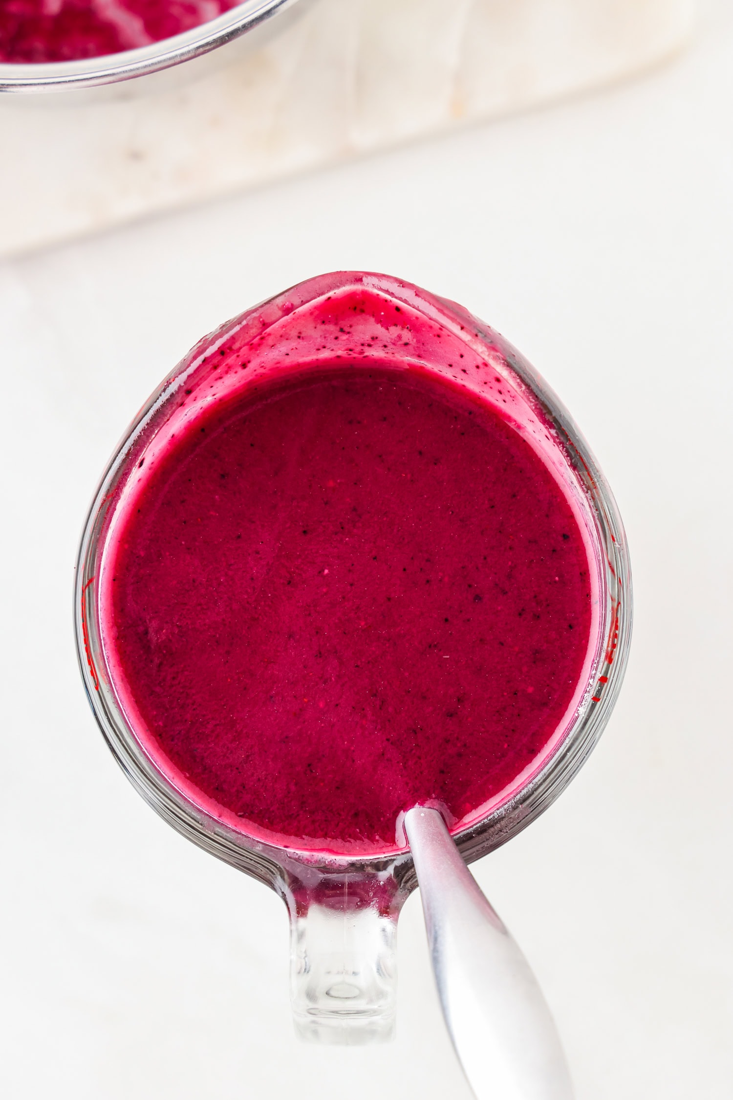 Purple fruit mixture blended in a glass measuring cup.