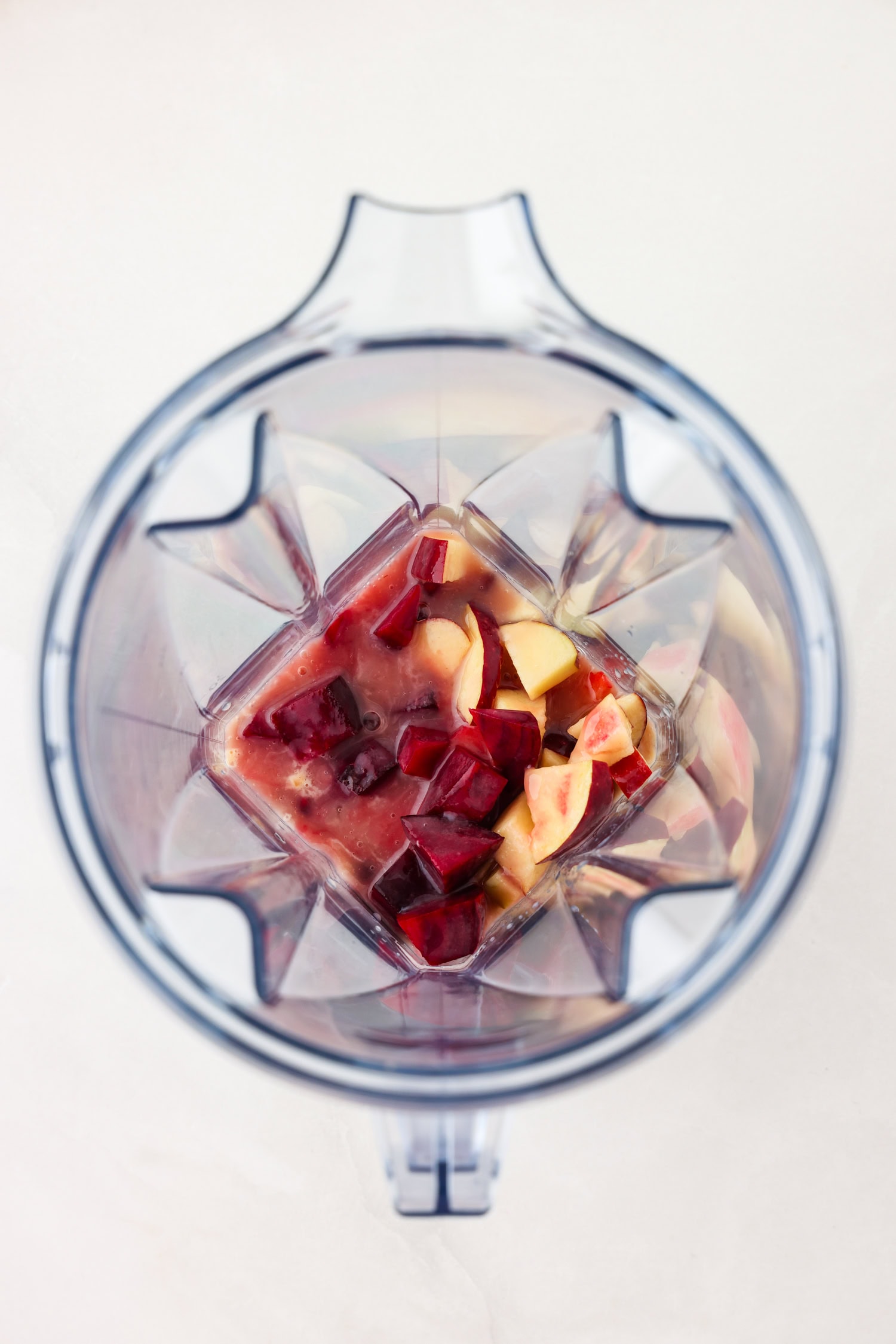 Red fruit mixture in a blender