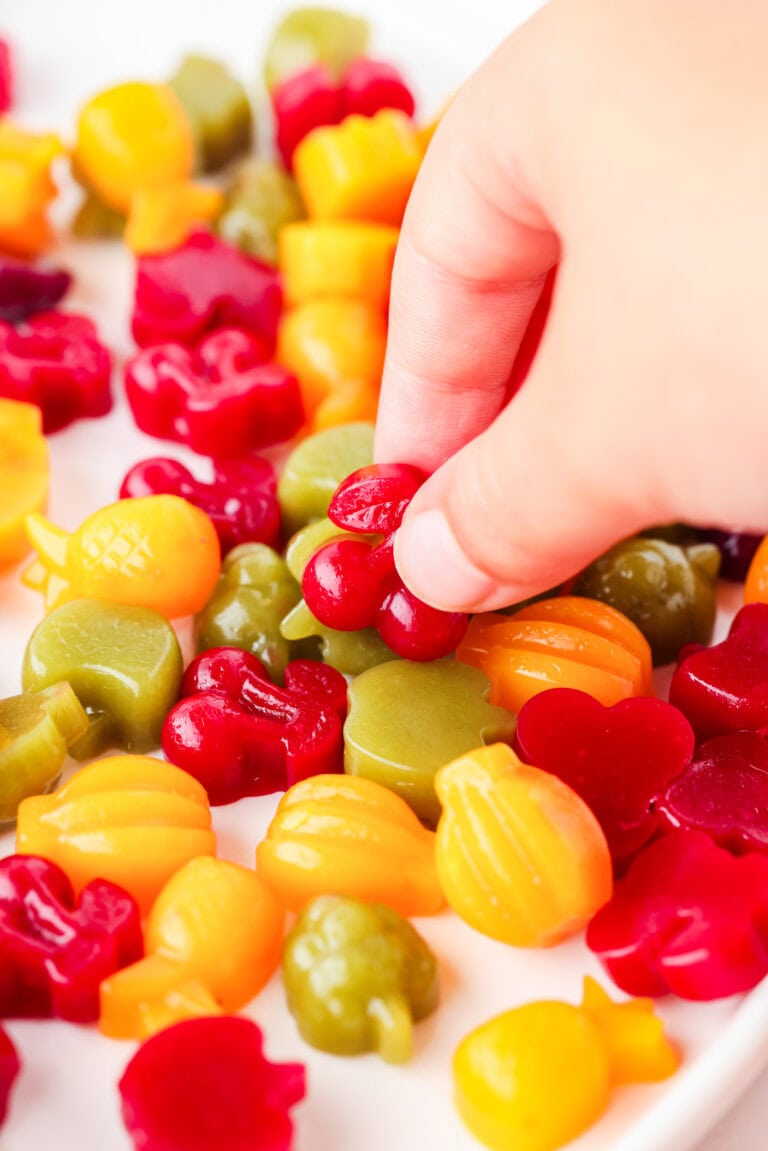 Picture of hand picking up cherry fruit snack mold.