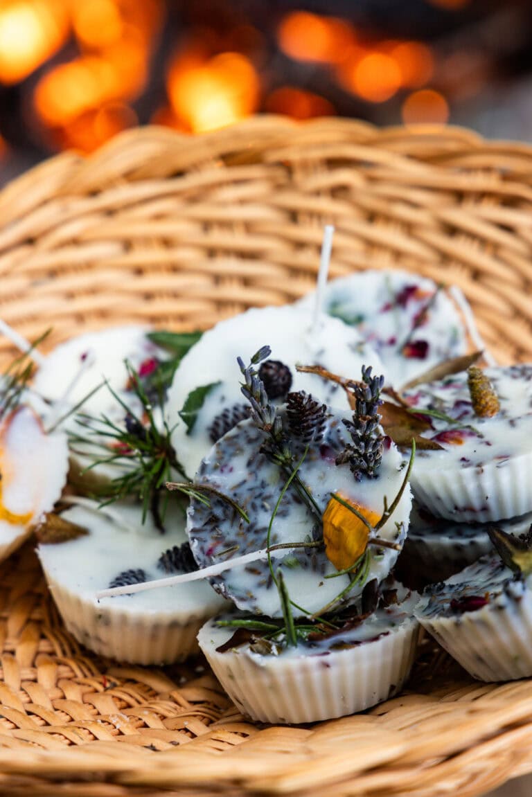 The campfire starters are displayed in a woven basket, with flames from a fire glowing warmly in the background.