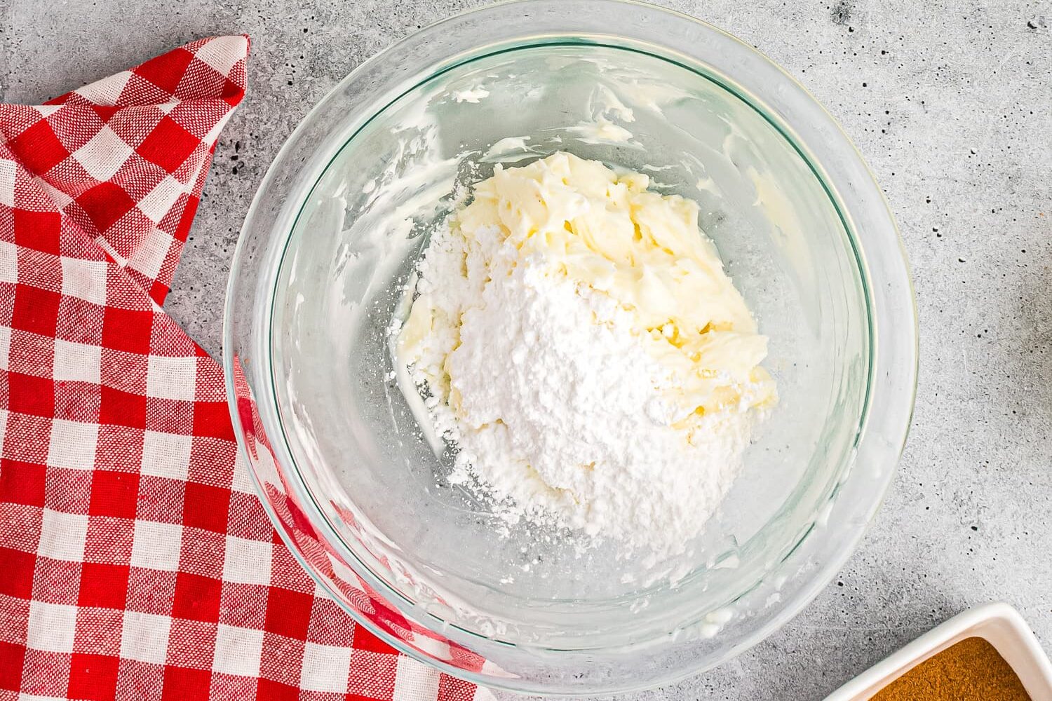 Cinnamon icing and powdered sugar in bowl