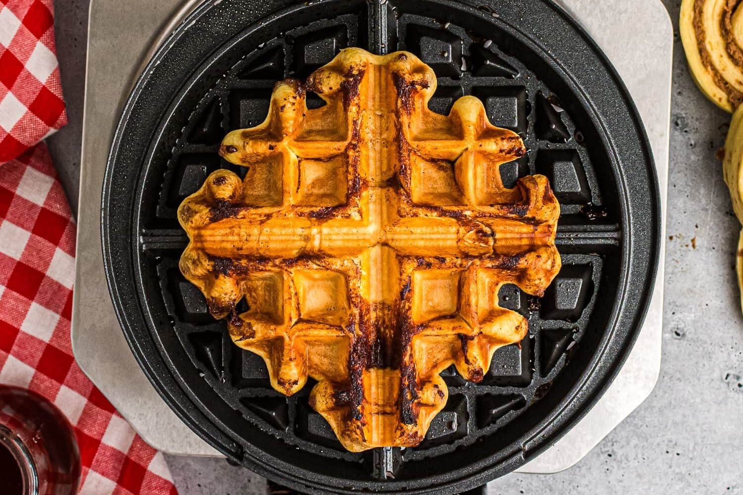 Cooked cinnamon roll on waffle maker