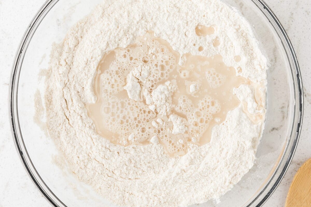 Gradually add water, stirring continuously. Goal is for a Smooth, pliable dough.