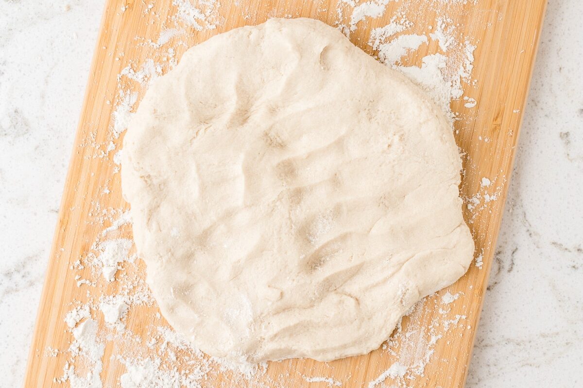 Dough flattened and ready to be rolled to be cut with cookie cutters.
