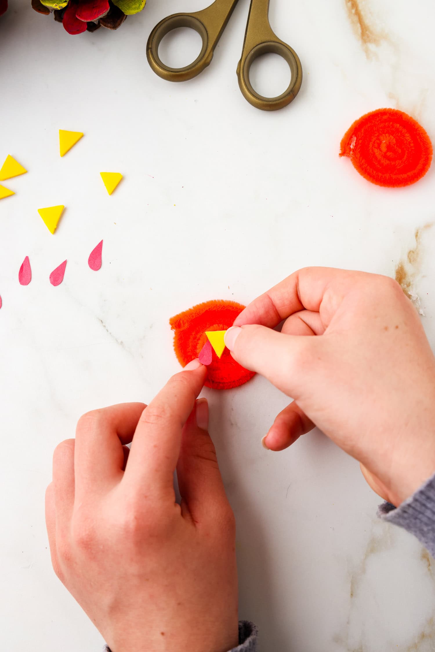 Picture of turkeys nose being glued onto pipecleaner