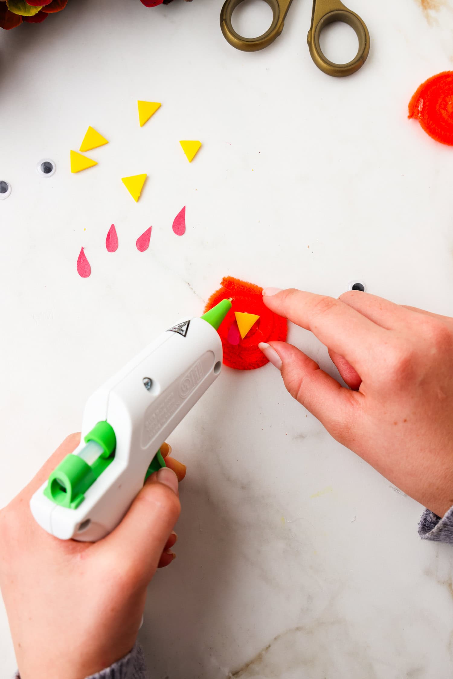 Picture of hot glue onto rolled up pipecleaner for googly eyes.