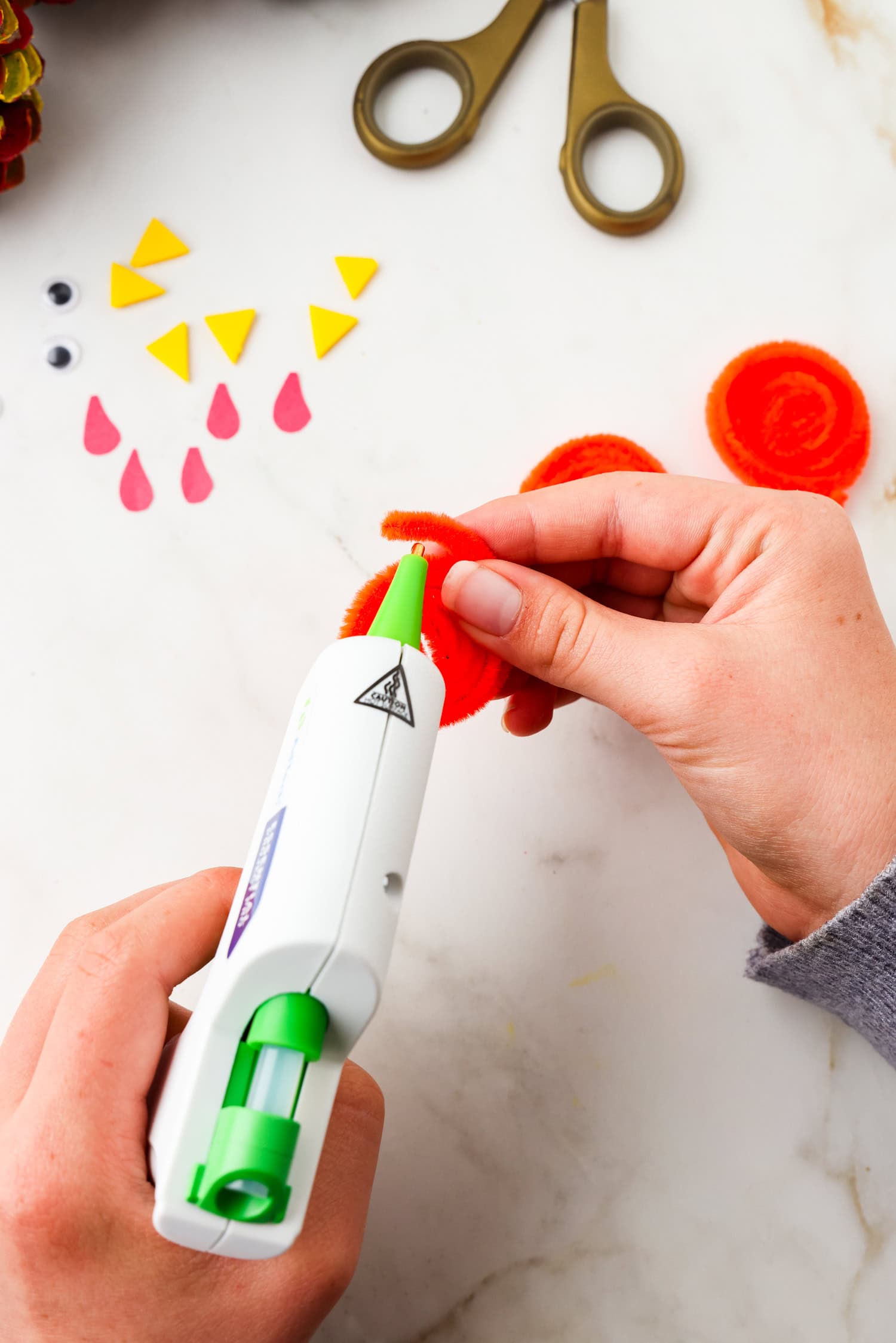 Picture of pipecleaner rolled up being glued on the end.