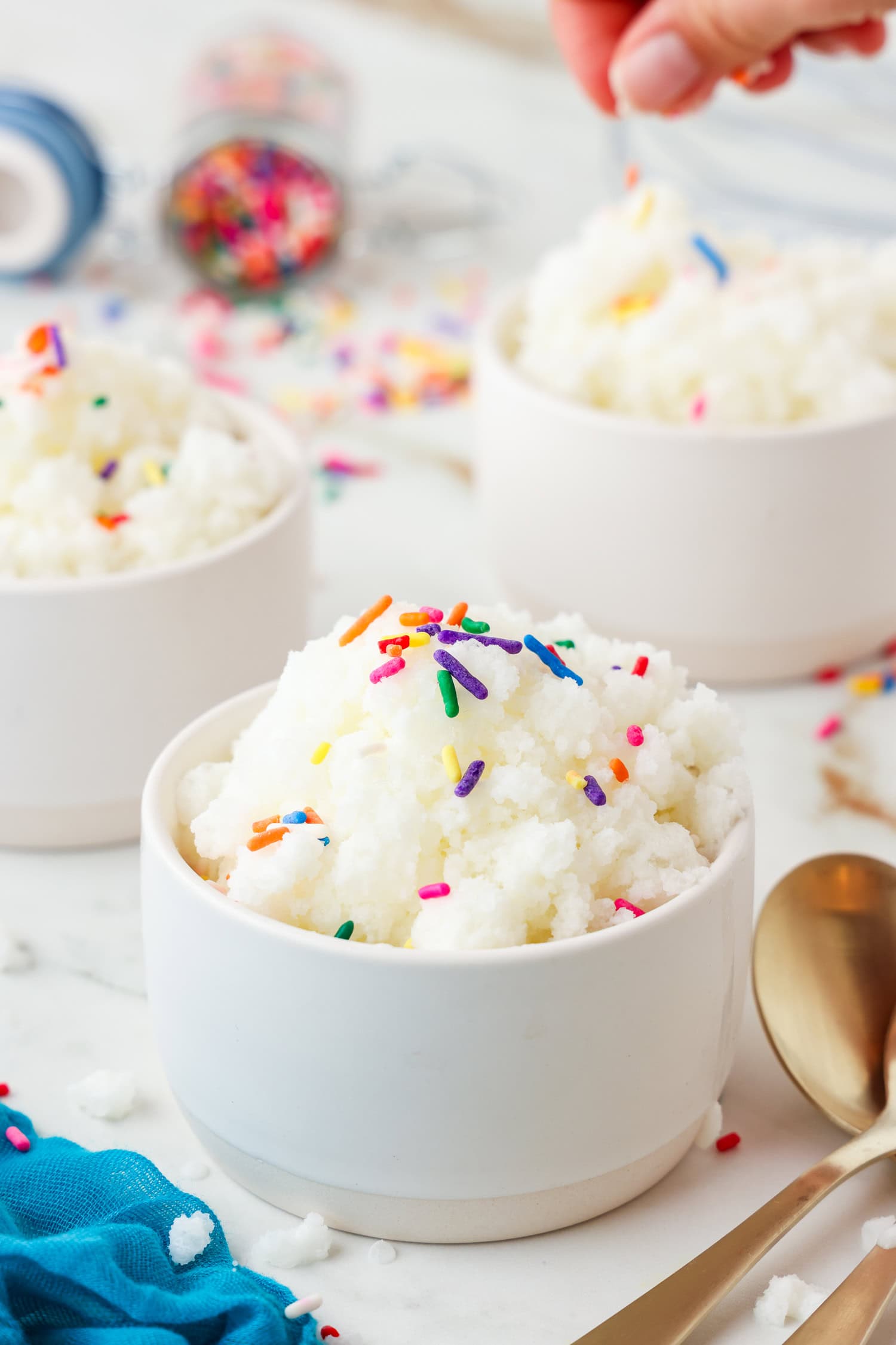 Snow ice cream in a white dish with sprinkles on top.