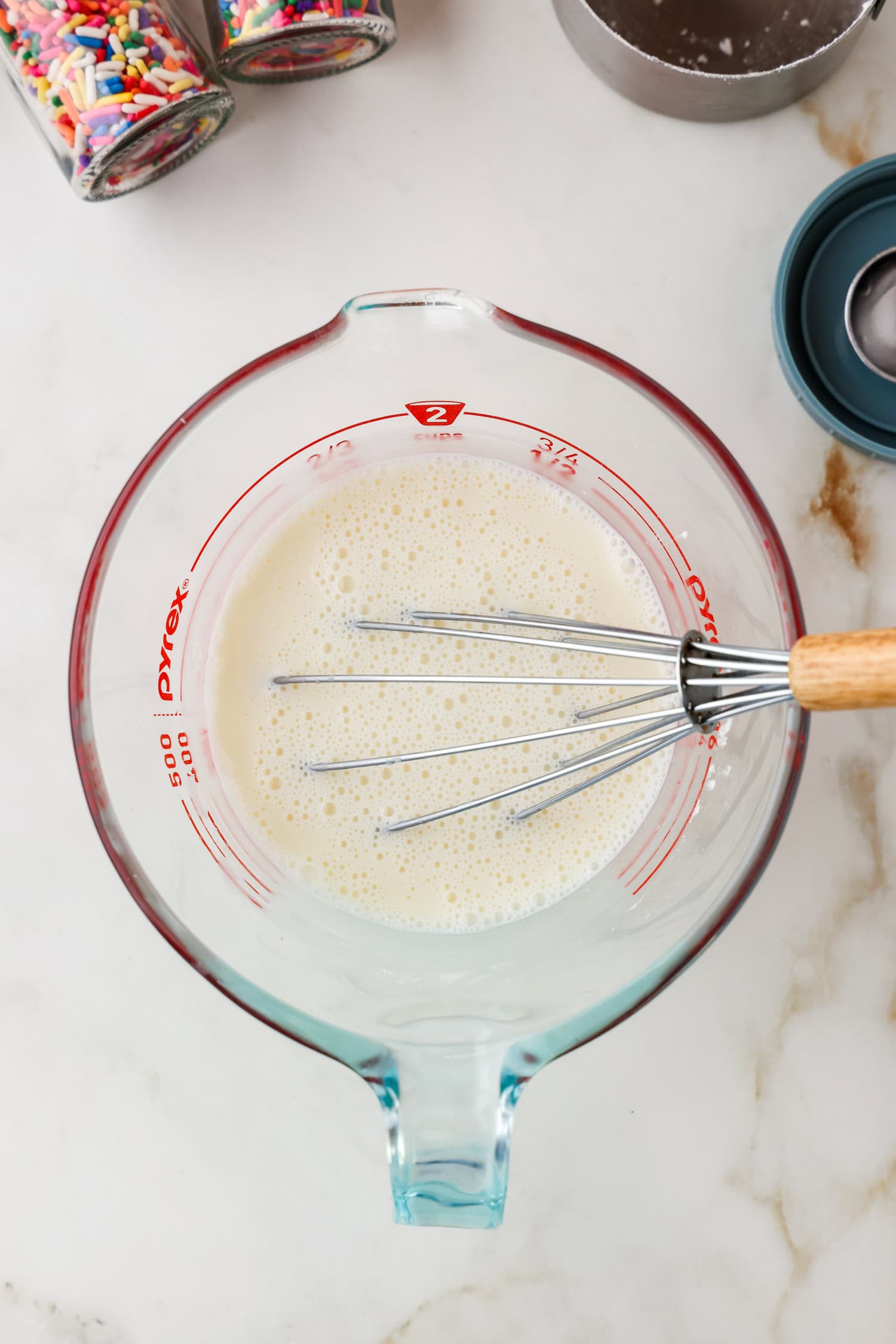 Whisk in the mixed heavy cream and powdered sugar mixture.